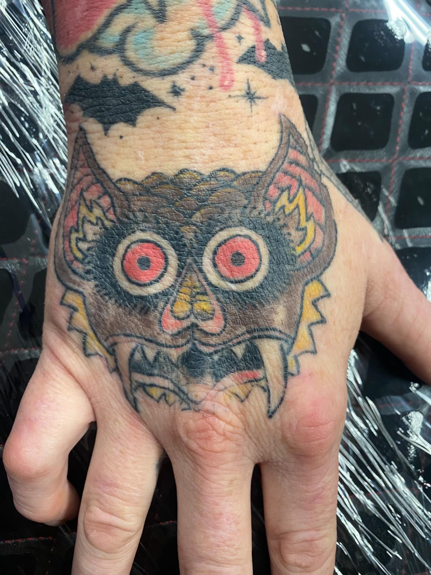 Owl skull American traditional tattoo on the hand by Drew