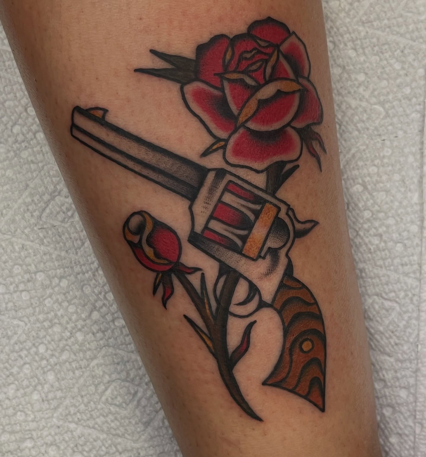 Chainsaw and rose American traditional tattoo on the forearm by August B., Renton, Washington