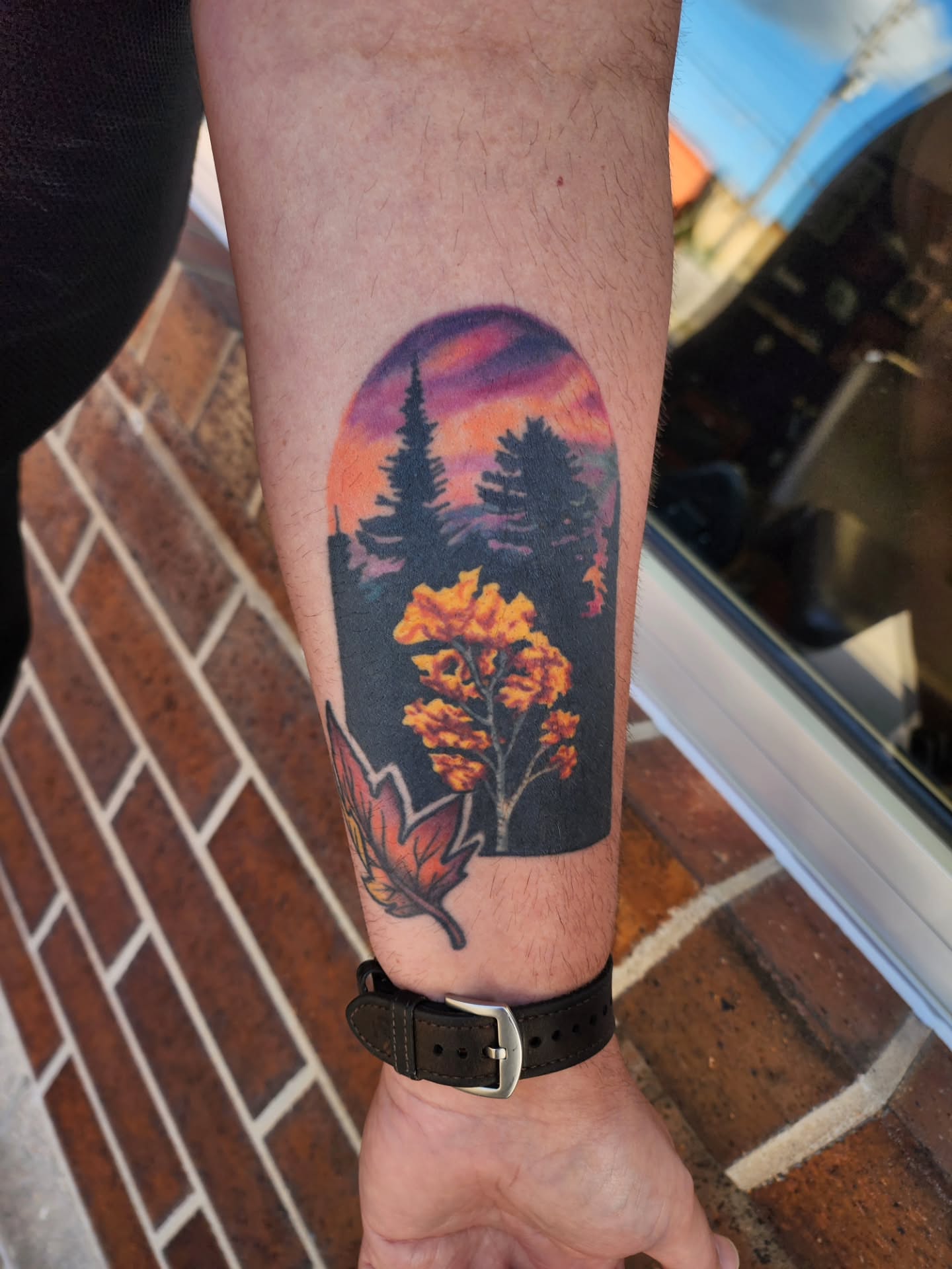 Autumn landscape realism tattoo on the forearm by Shawna Goettsche