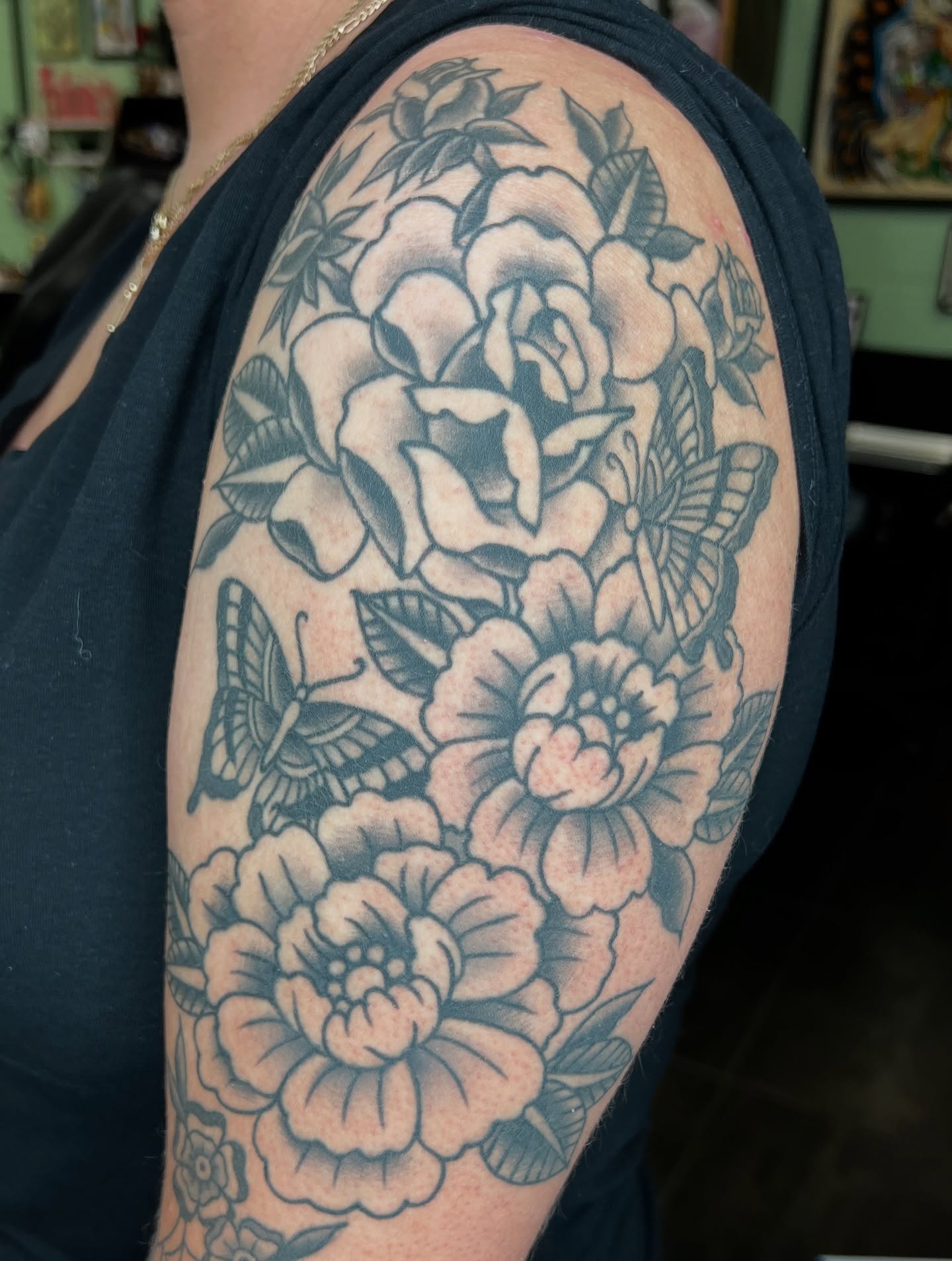 Floral bouquet American traditional tattoo on the upper arm by Aiden Krone, San Diego, California