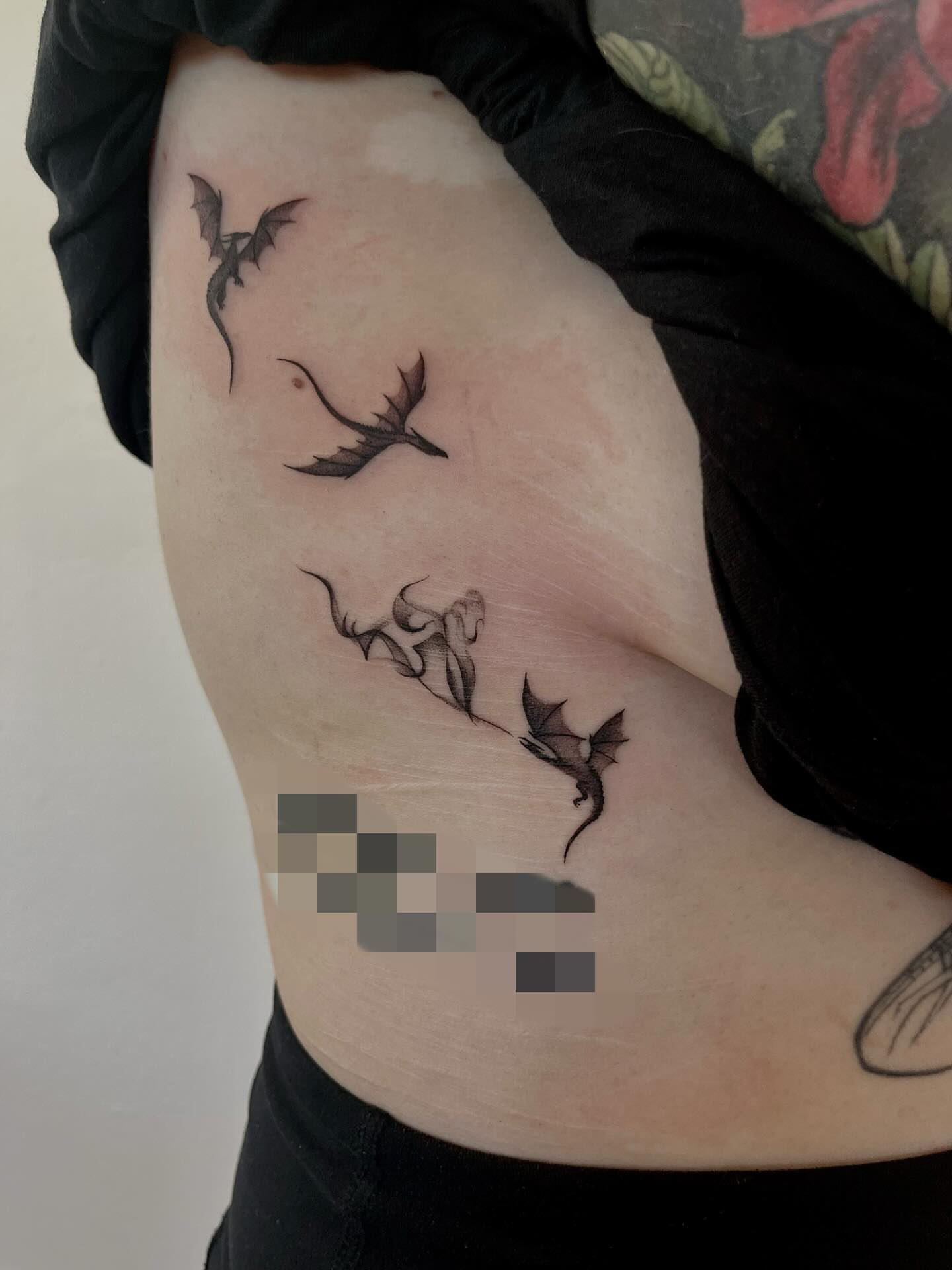 Dragons and flower black and grey tattoo on the ribs by Kite.Tattoo_Amber