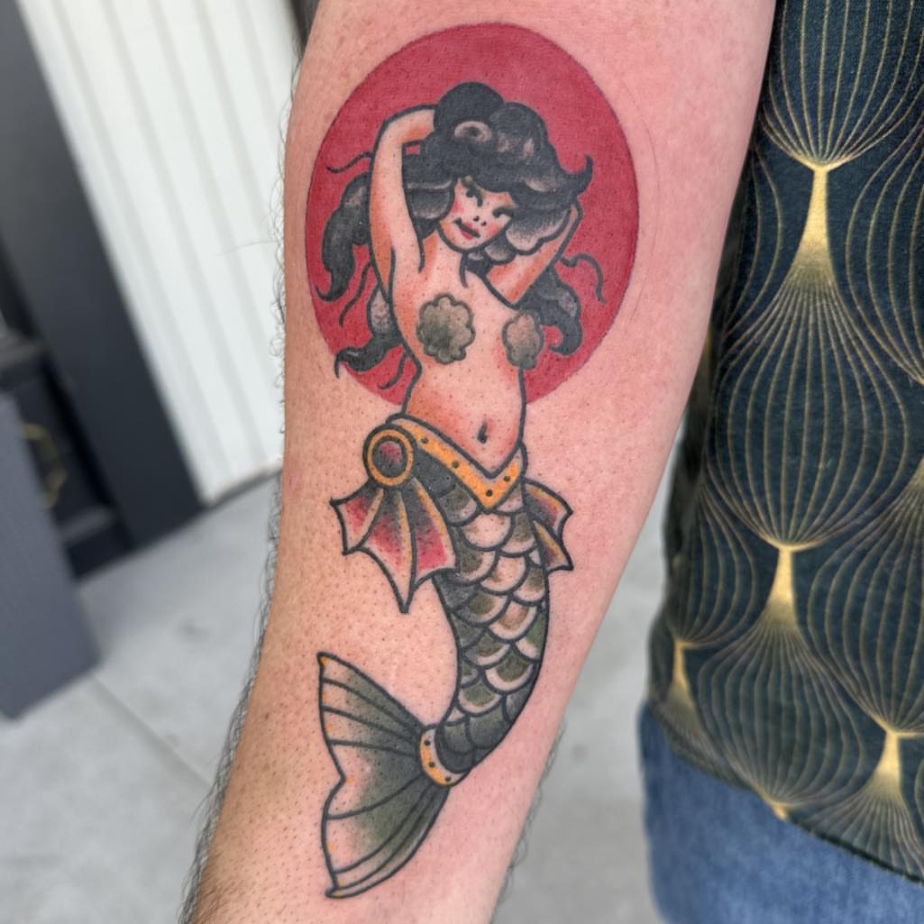 Mermaid American traditional tattoo on the forearm by Tattoos by Aeron Herald Maurbjorn, Sioux