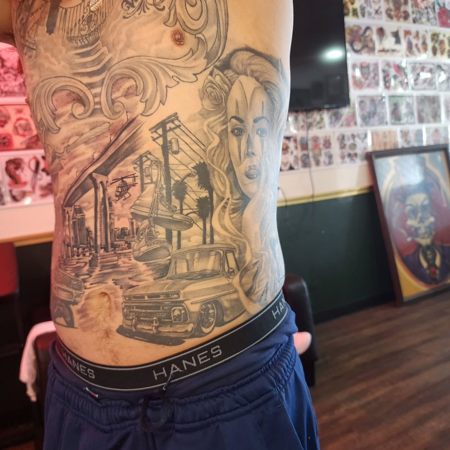 Cityscape with woman realism tattoo on the torso by Joe Garcia
