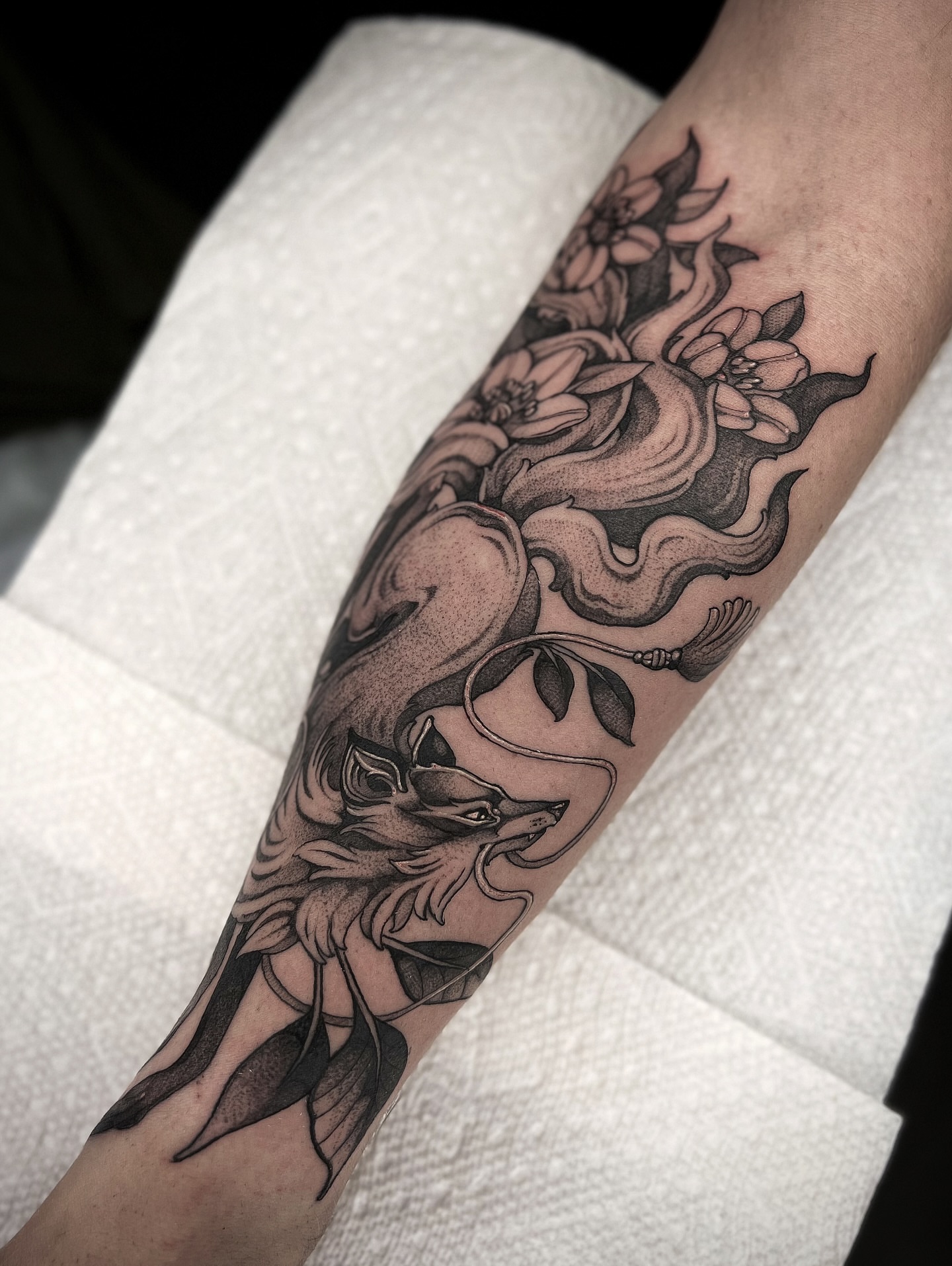 Fox and flowers dotwork tattoo on the forearm by Kaysee Shuster