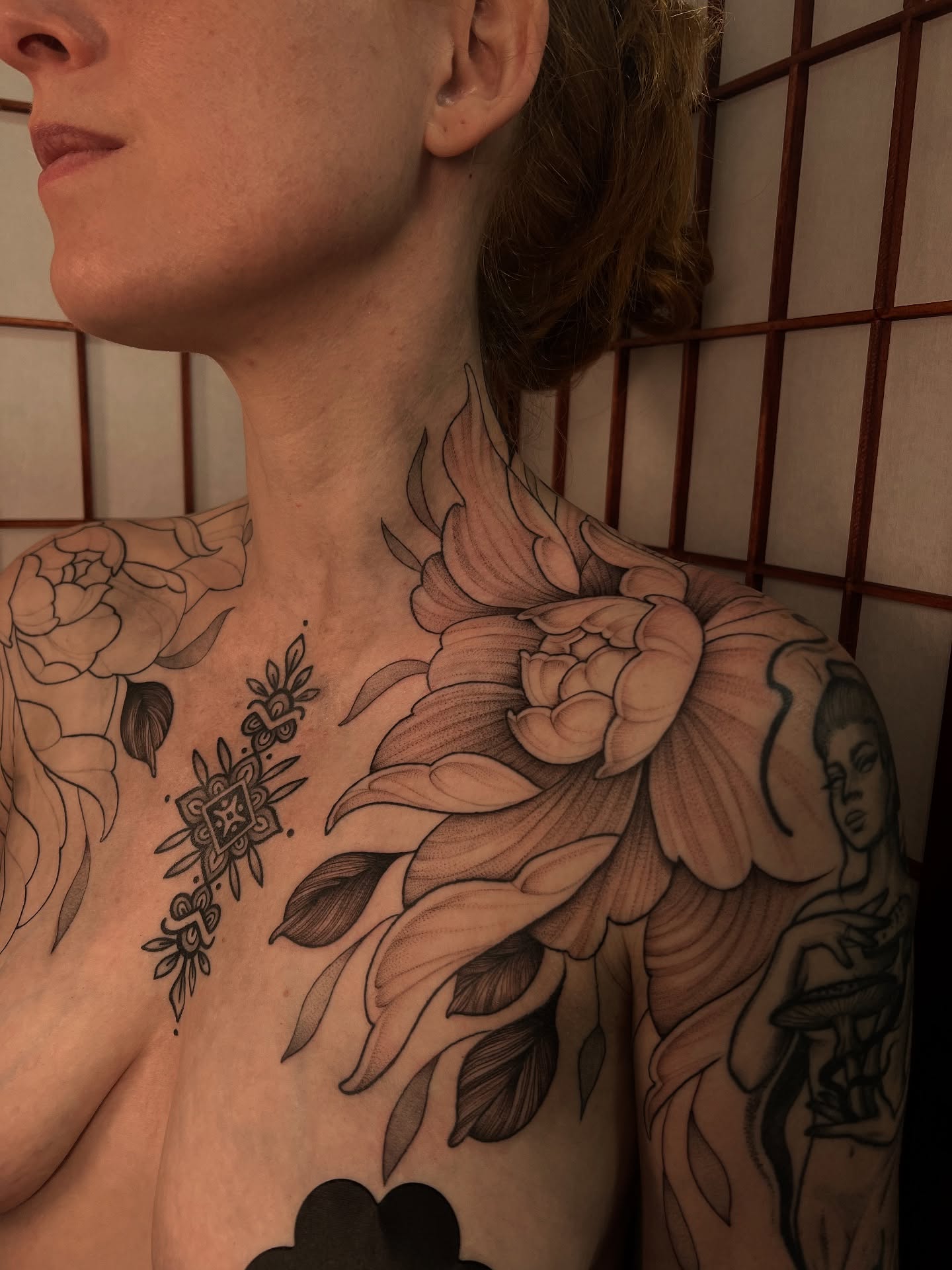Floral black and grey tattoo on the chest by Avrey Simone