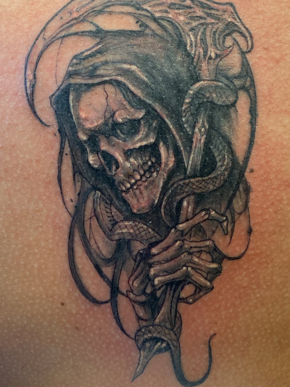 Grim reaper dark realism tattoo on the shoulder by Hecho En El Bronx