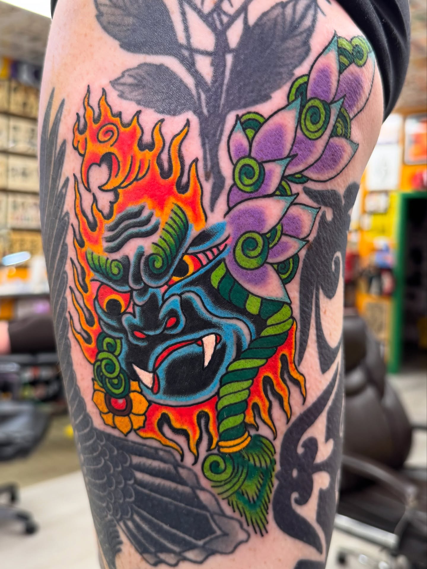 Demon mask with flames japanese irezumi tattoo on the thigh by Timothy Wood