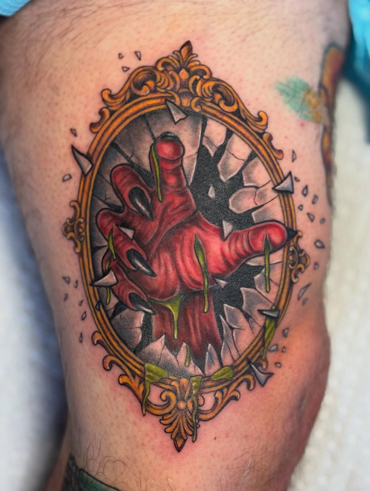Hand breaking through mirror dark realism tattoo on the thigh by @carissaetattoos