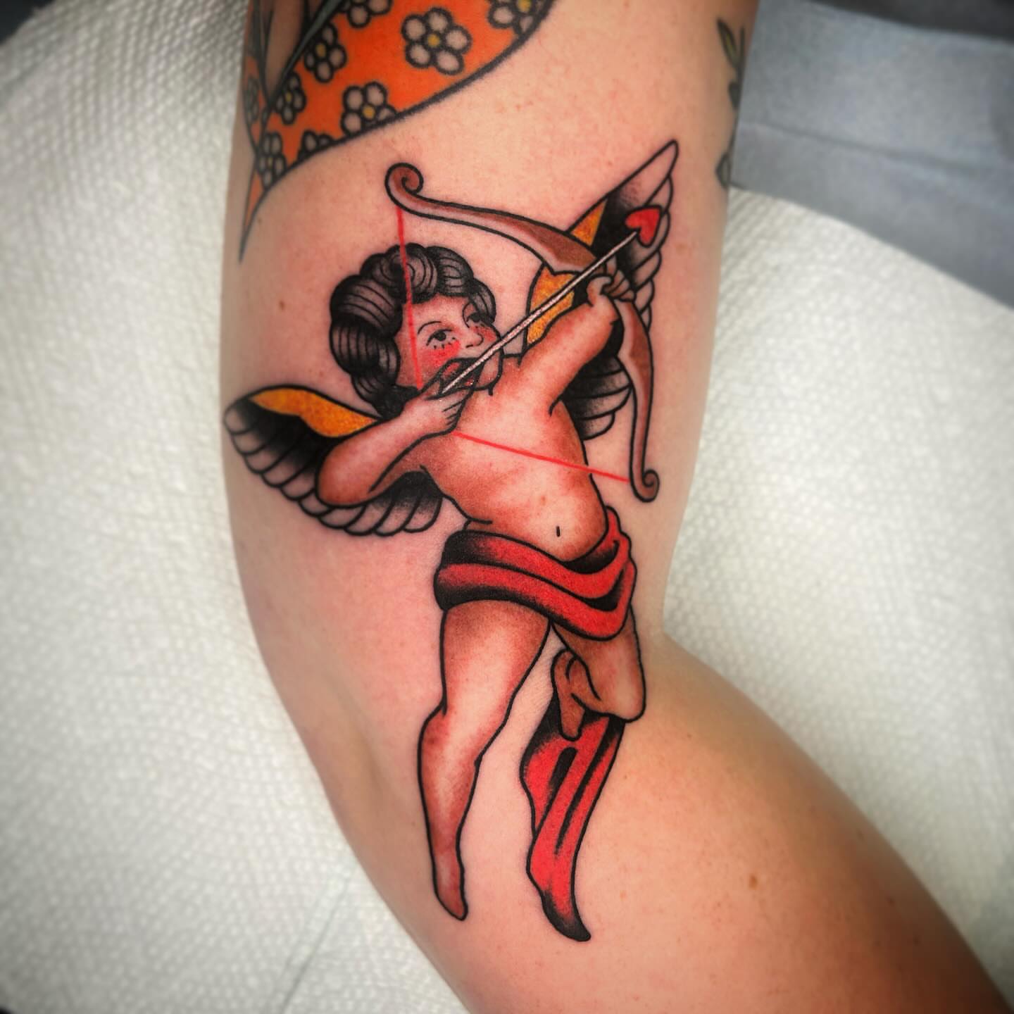 Cupid American traditional tattoo on the forearm by Kayla Shoffner