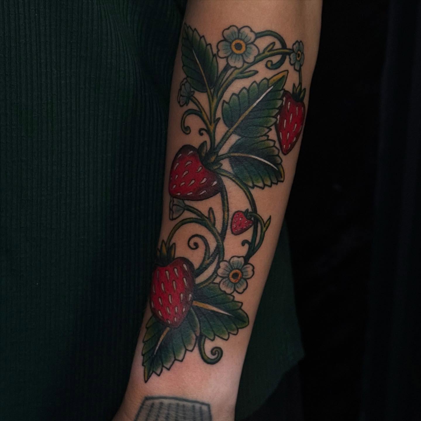 Strawberry vine American traditional tattoo on the forearm by Jacie Aasen-Lupino