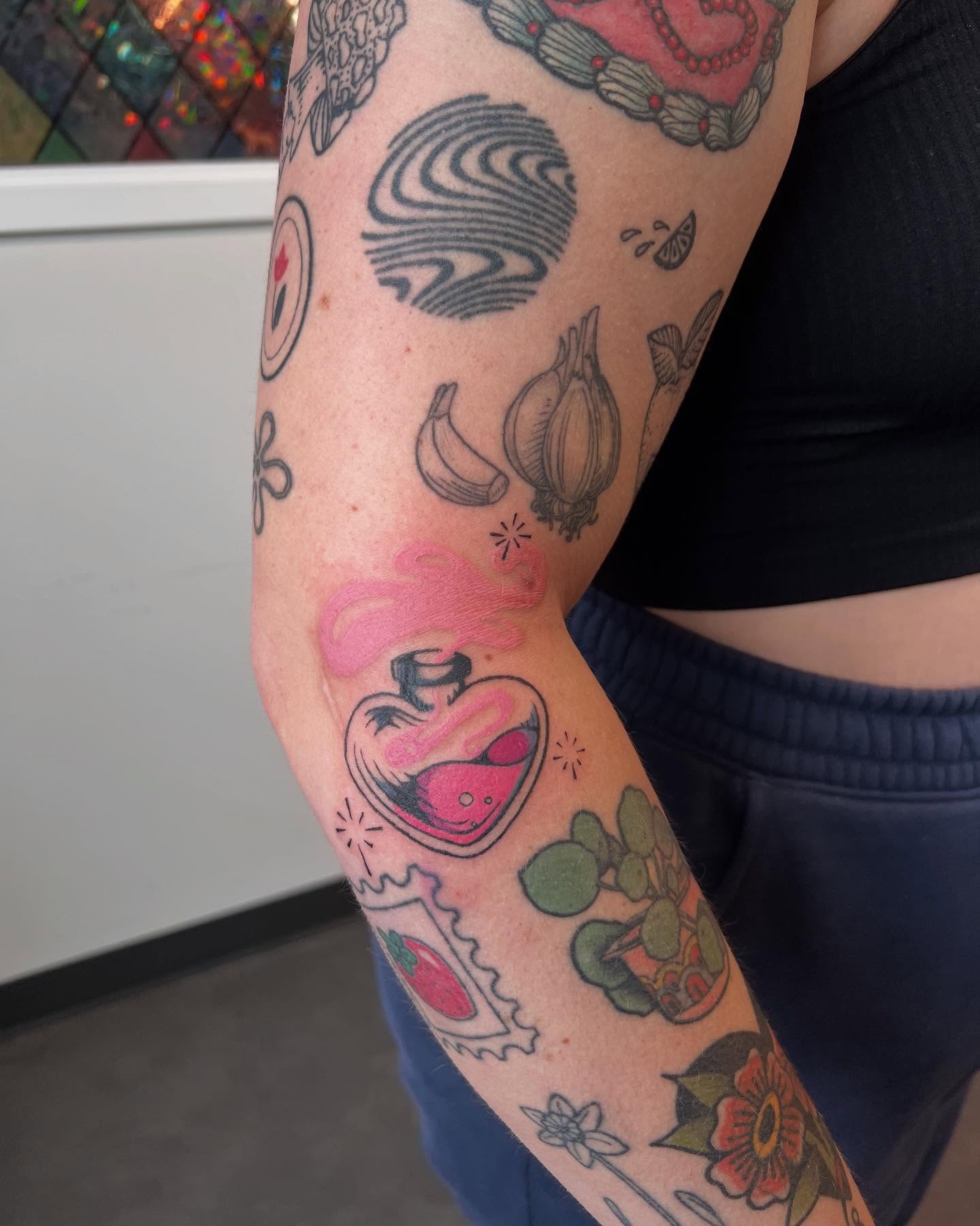 Heart with potion American traditional tattoo on the forearm by rachel