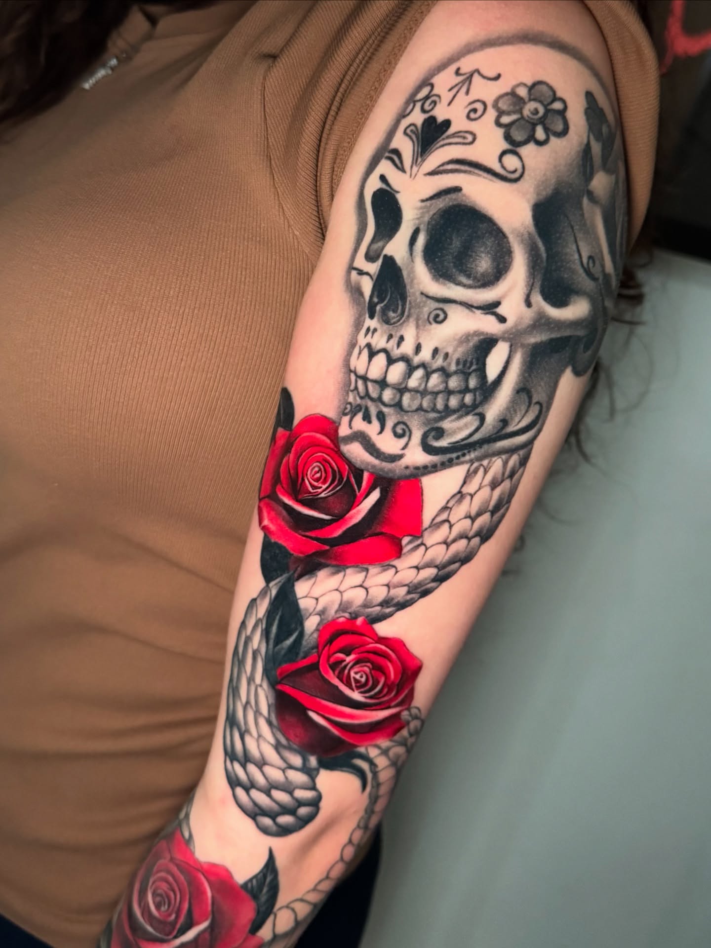 Skull and roses realism tattoo on the forearm by Gabriel Quintana “Q”