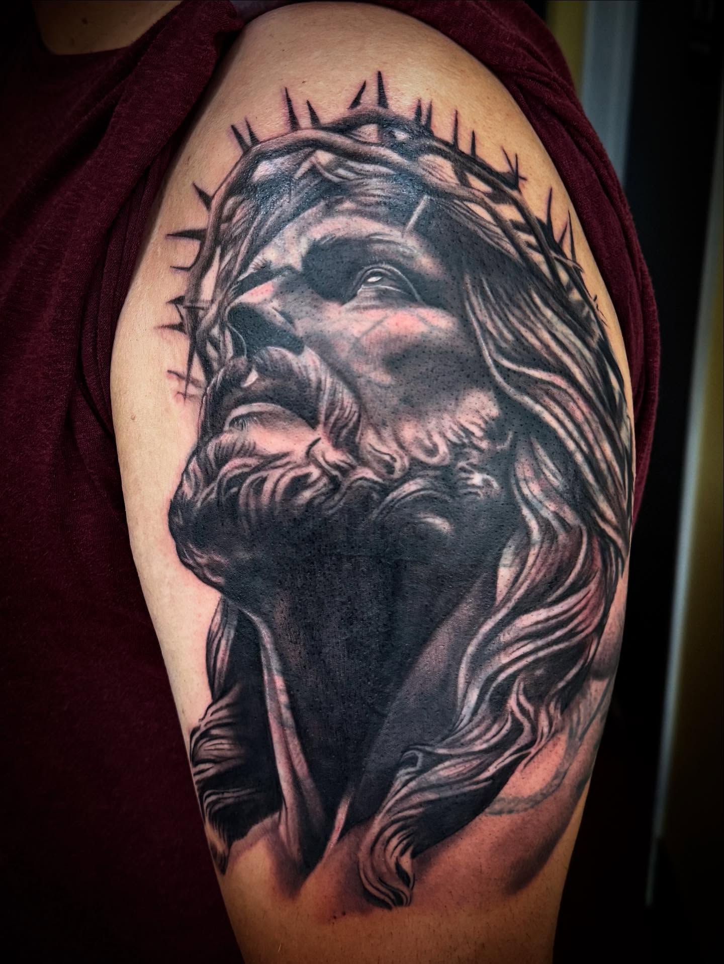 Jesus Christ realism tattoo on the shoulder by Tanner Pastor
