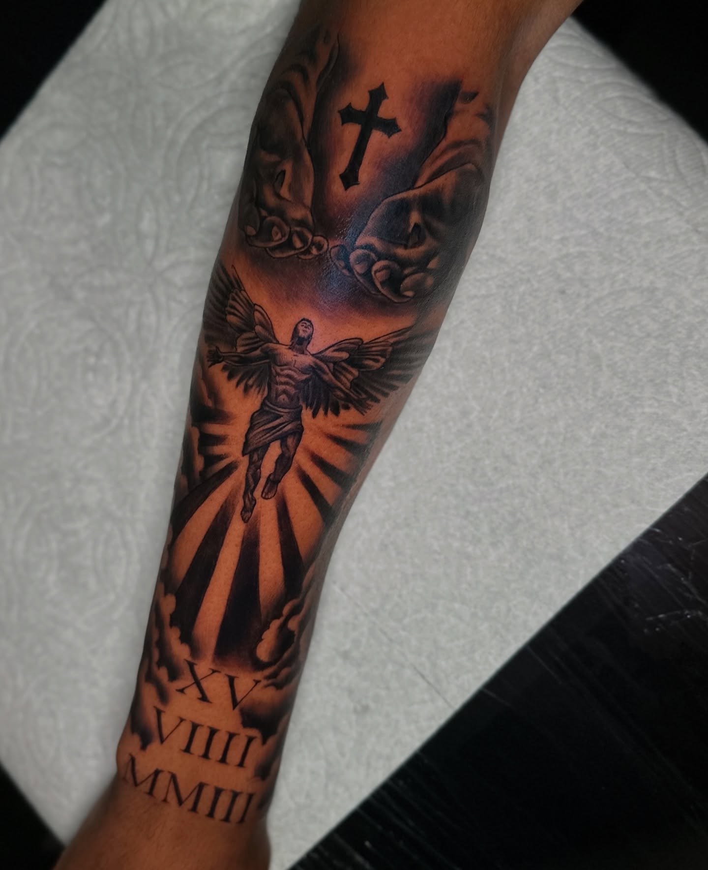 Angelic figure realism tattoo on the forearm by Mando