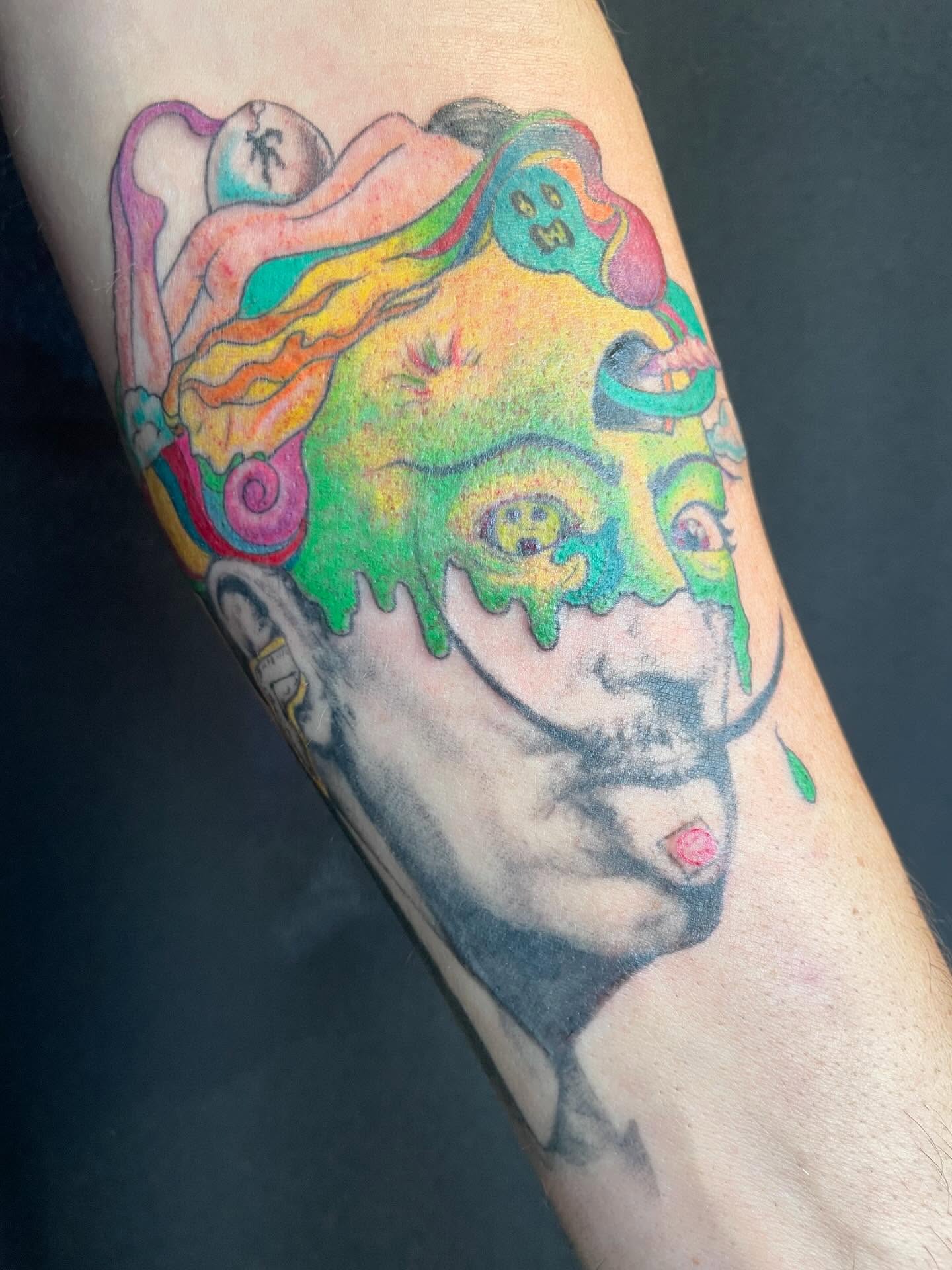 Psychedelic face new school tattoo on the forearm by Christin Baumgart