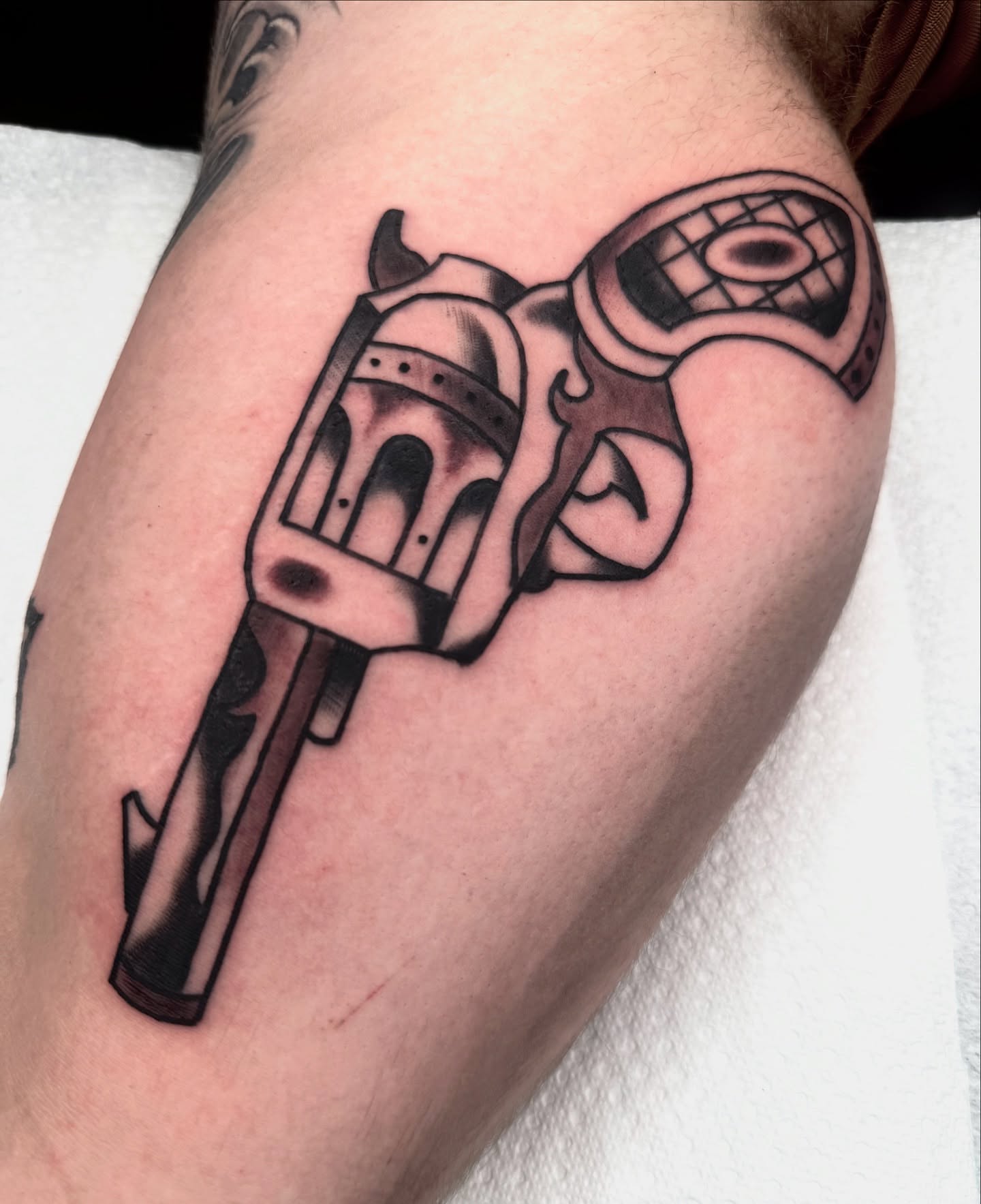 Revolver black and grey tattoo on the forearm by Drew🕸️, Phoenix, Arizona