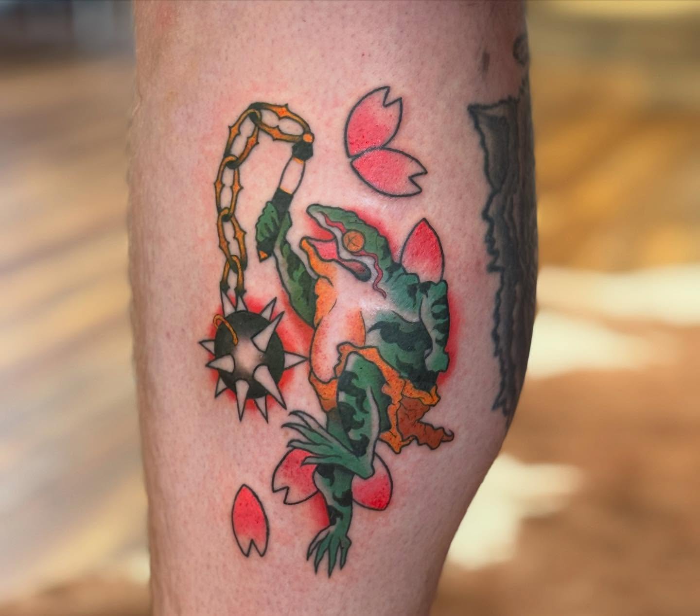 Frog and bomb American traditional tattoo on the forearm by MJ Saunders