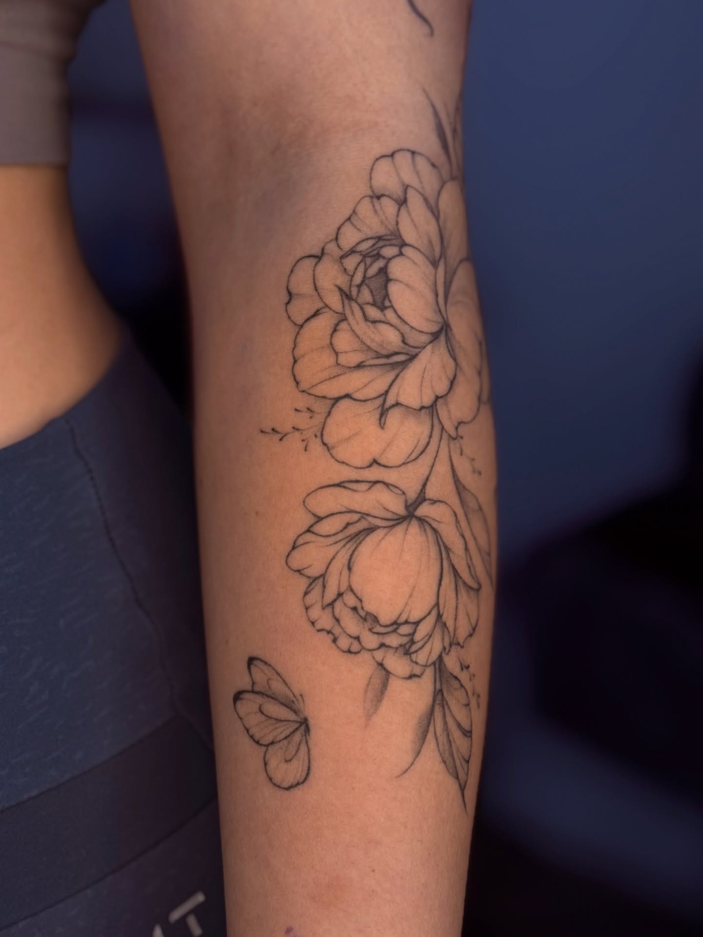 Flowers black and grey tattoo on the forearm by Daria