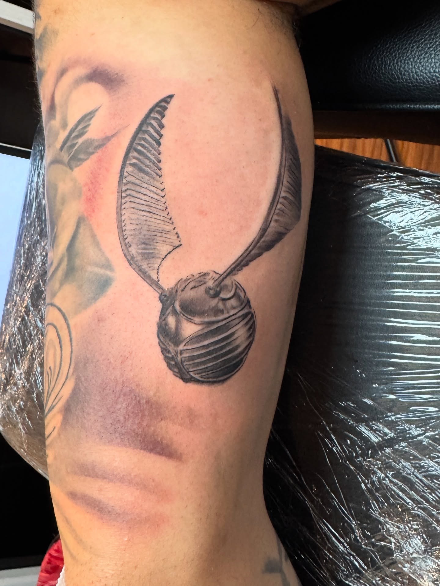 Golden snitch black and grey tattoo on the forearm by Davier Del Castillo