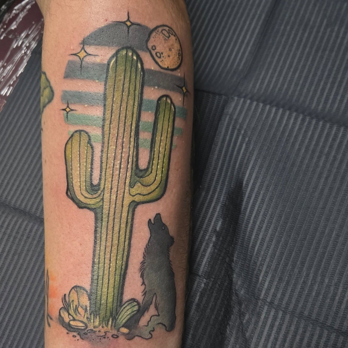 Desert landscape American traditional tattoo on the forearm by Jamie Clinton