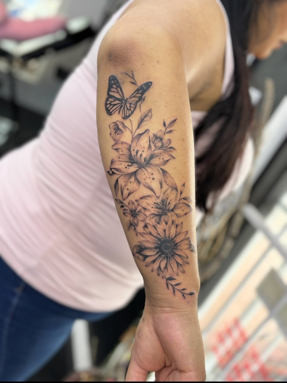 Flowers and butterfly black and grey tattoo on the forearm by $weet little leslie 🩶🧚🏻‍♀️