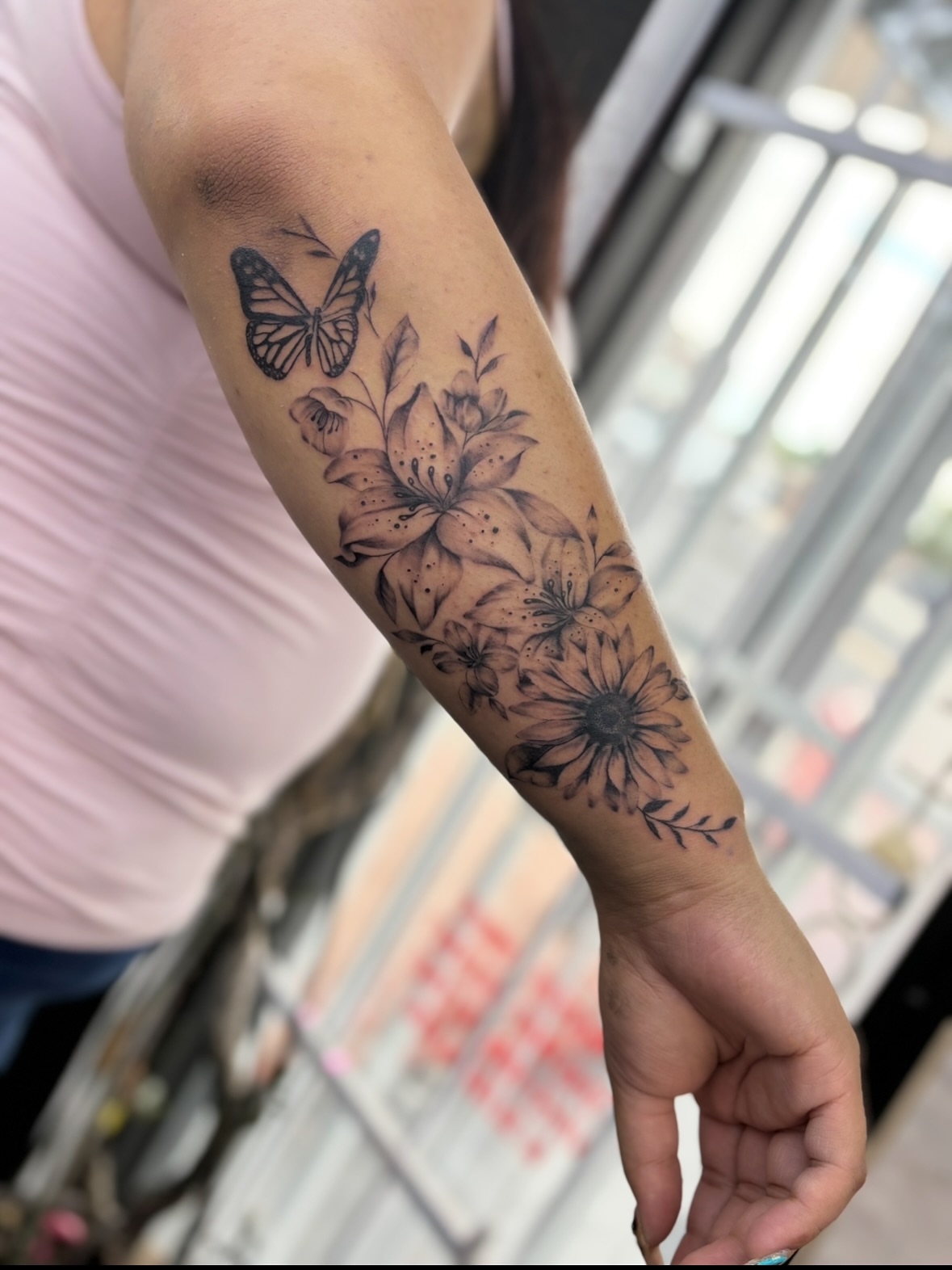 Butterfly and flowers black and grey tattoo on the forearm by $weet little leslie 🩶🧚🏻‍♀️