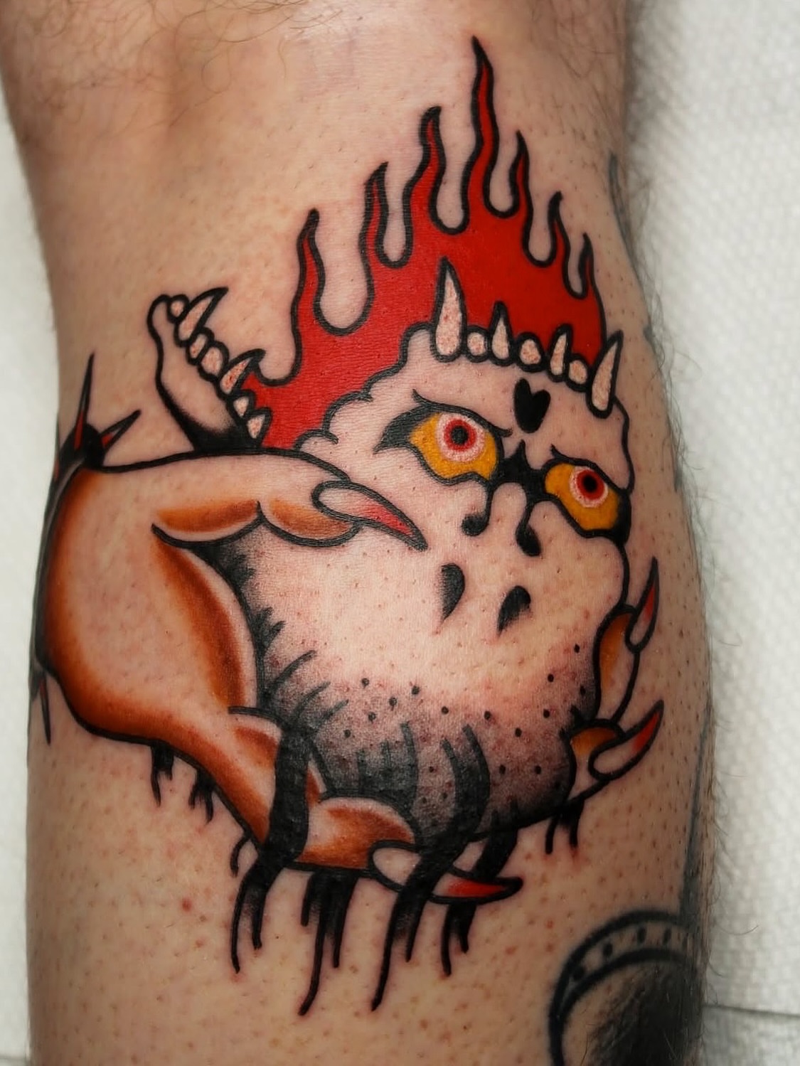 Owl with flames American traditional tattoo on the forearm by Kehrmie Tattoos, Berkeley, California