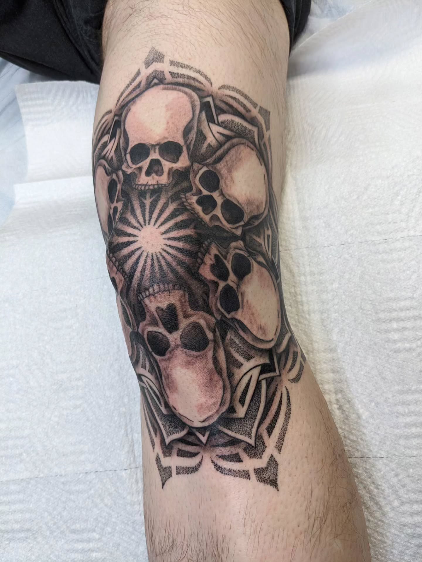 Skulls and gears geometric tattoo on the forearm by Ed Gonzalez