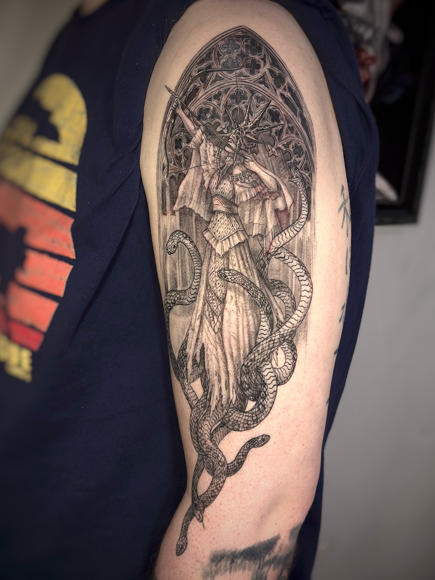 Religious figure with snakes realism tattoo on the forearm by Jemin Ren