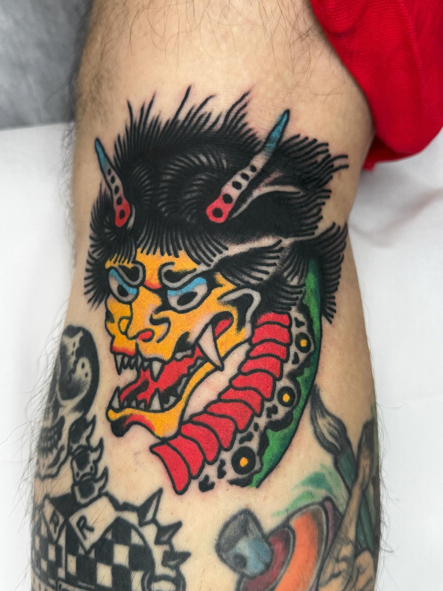 Japanese demon mask American traditional tattoo on the forearm by Jimmy Ho