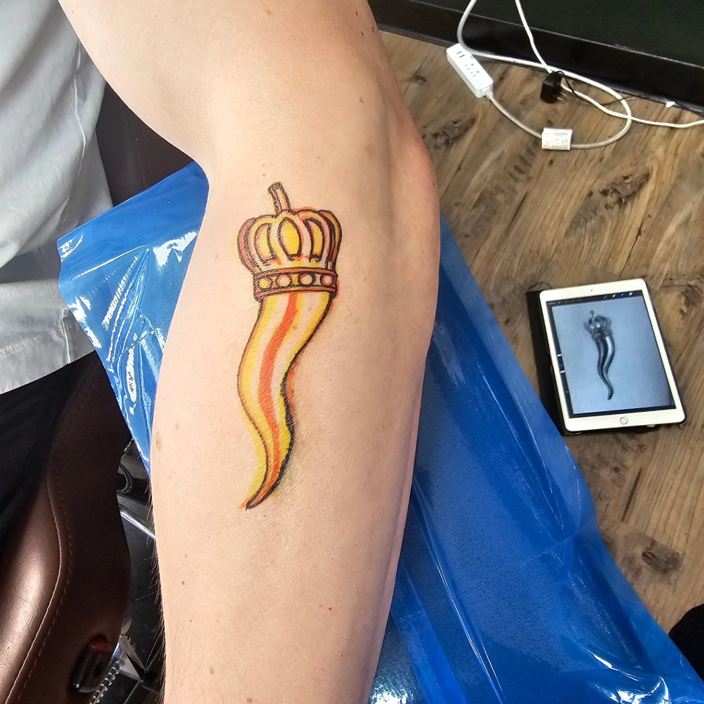 Crown and flame neo-traditional tattoo on the forearm by Derek Davis