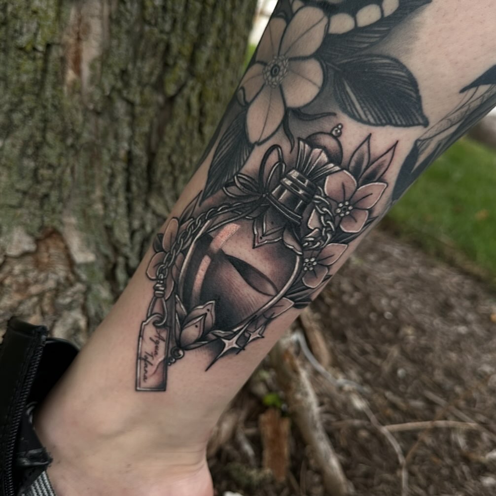 Mask with flowers realism tattoo on the forearm by Javier Rivera