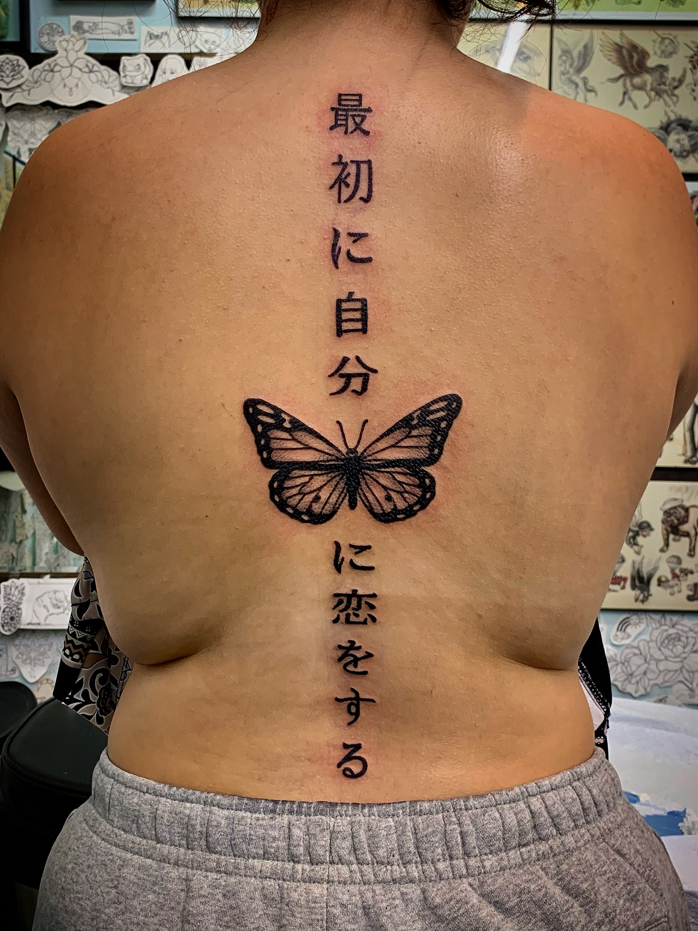 Butterfly and kanji black and grey tattoo on the back by Laura