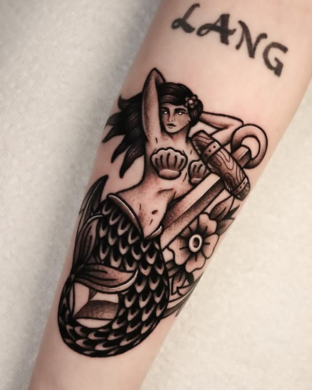 Mermaid American traditional tattoo on the forearm by Jeff Reindel