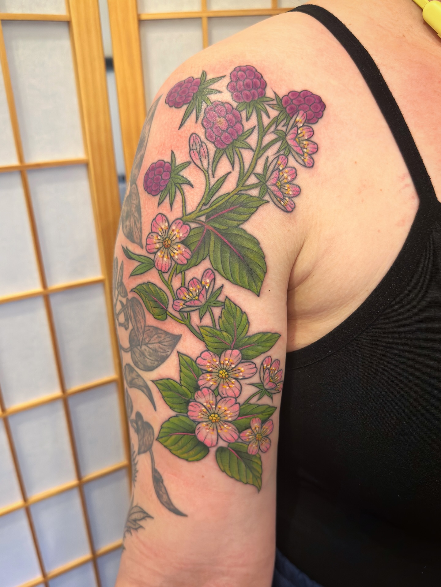 Flower bouquet realism tattoo on the upper arm by Tattooing by Patty Valentine