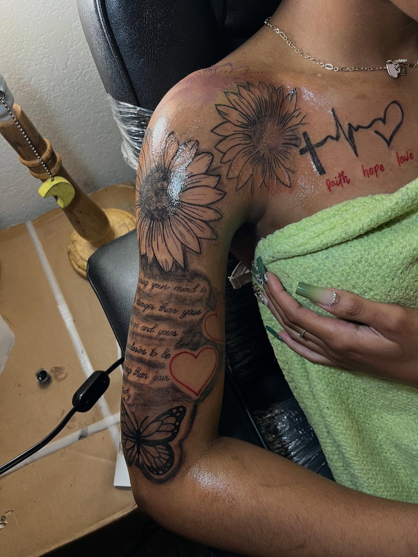 Sunflowers and hearts black and grey tattoo on the upper arm by Dm To Book ๐, Charlotte, North Carolina