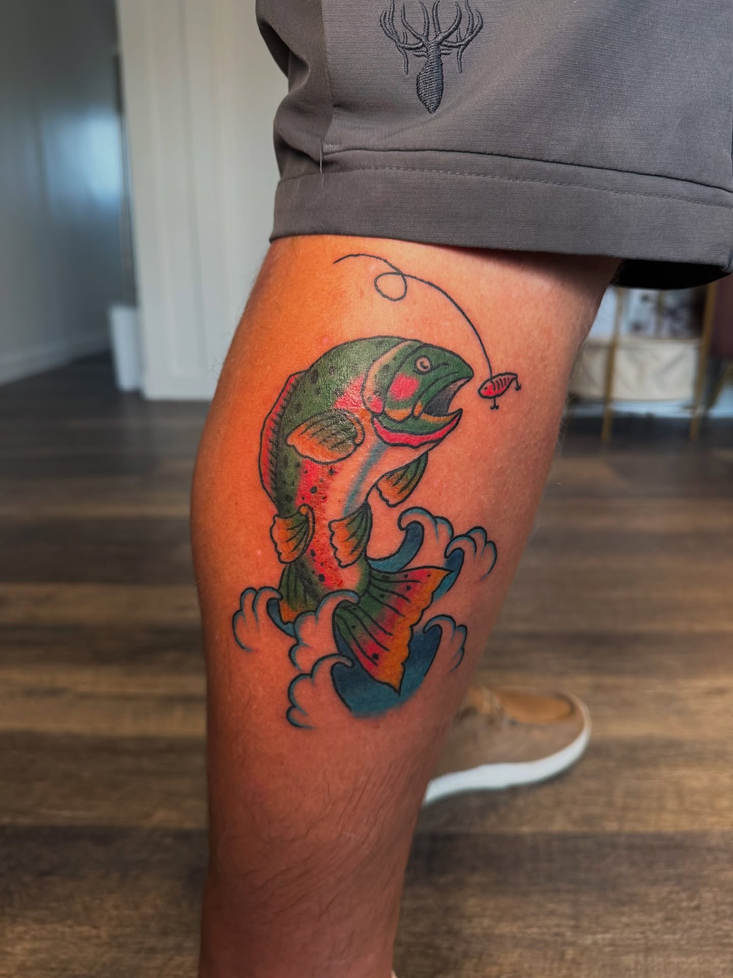 Rainbow trout American traditional tattoo on the thigh by Kinzi Brown