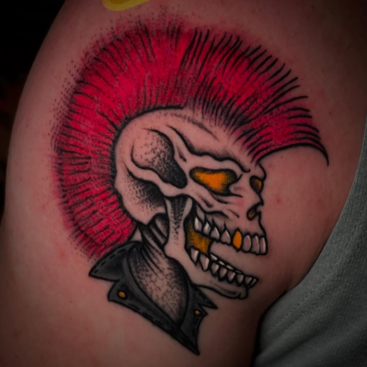 Punk skull American traditional tattoo on the shoulder by Madison ‘Maddog’ Stewart