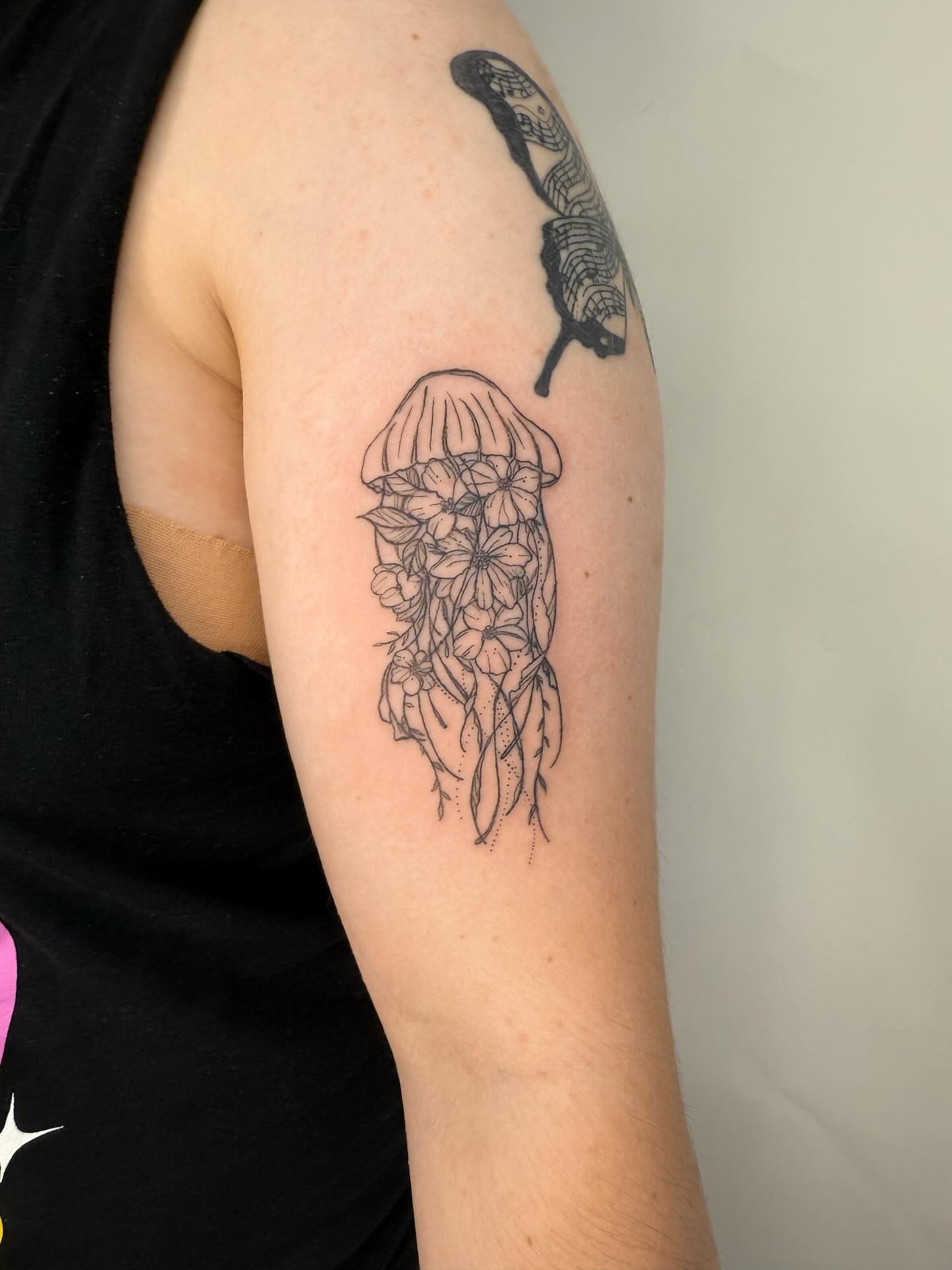 Jellyfish with flowers dotwork tattoo on the forearm by Joey tattoo