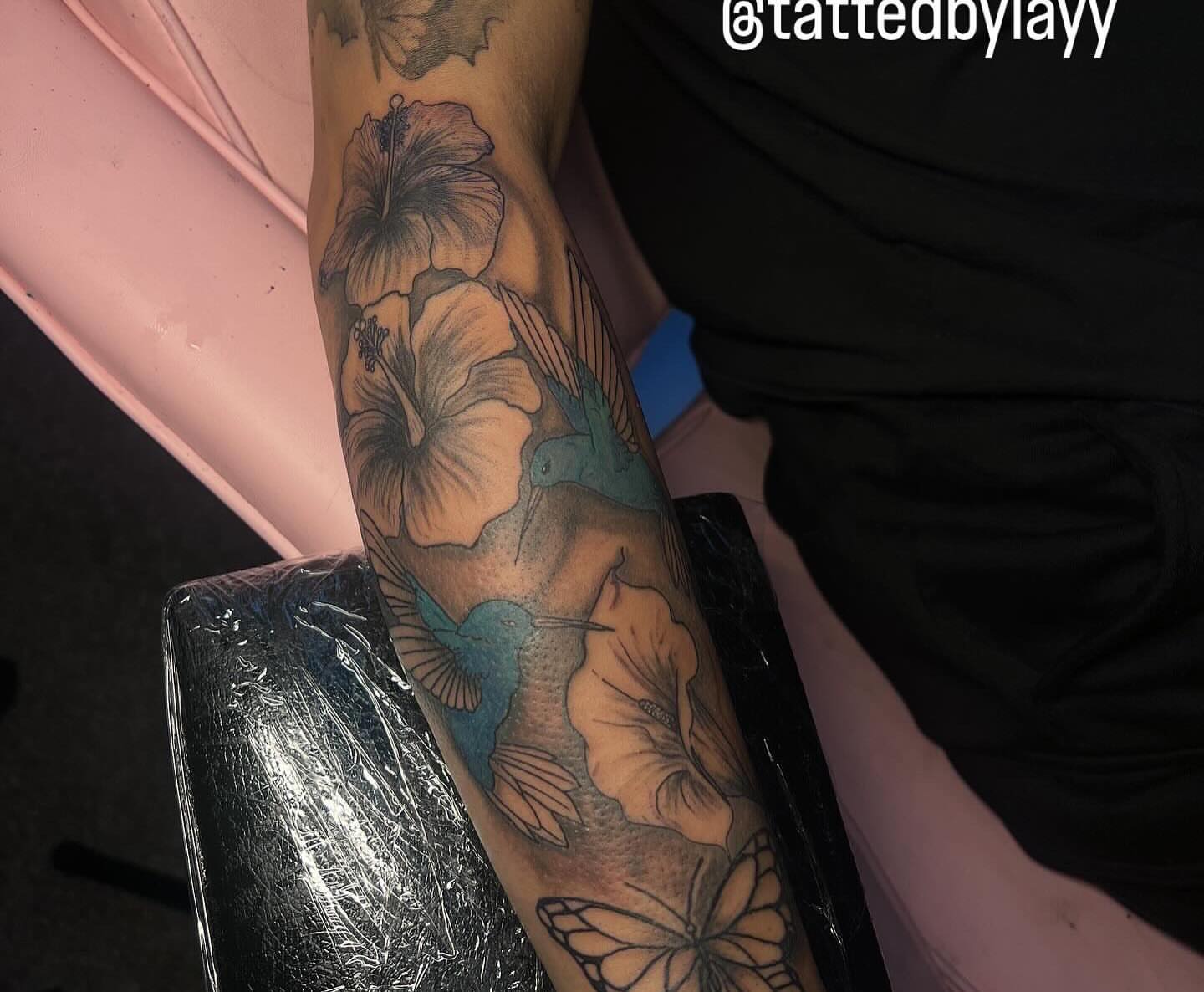 Hibiscus flowers and hummingbirds realism tattoo on the forearm by Tatted By Layy