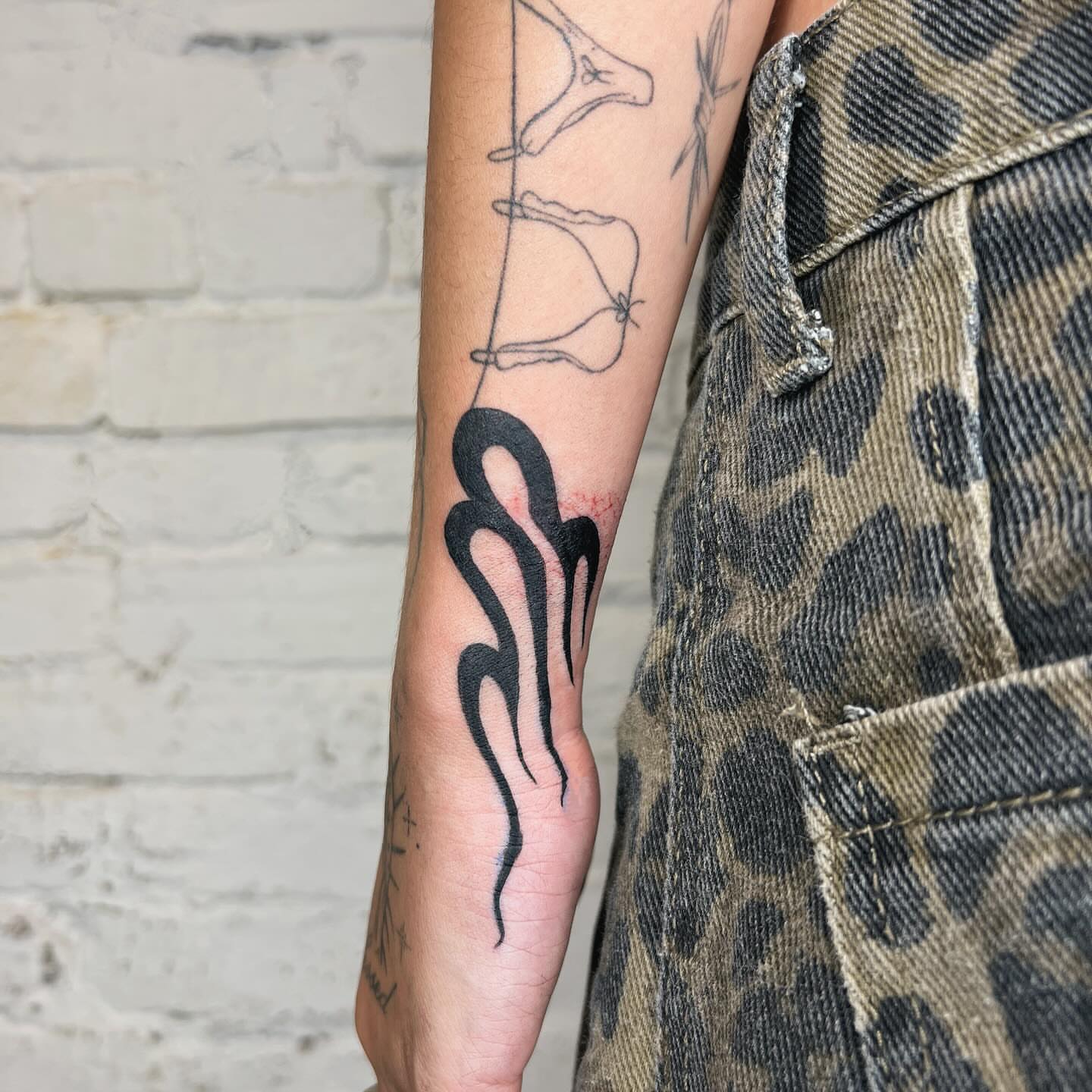 Flame tribal tattoo on the forearm by Robb Wilson