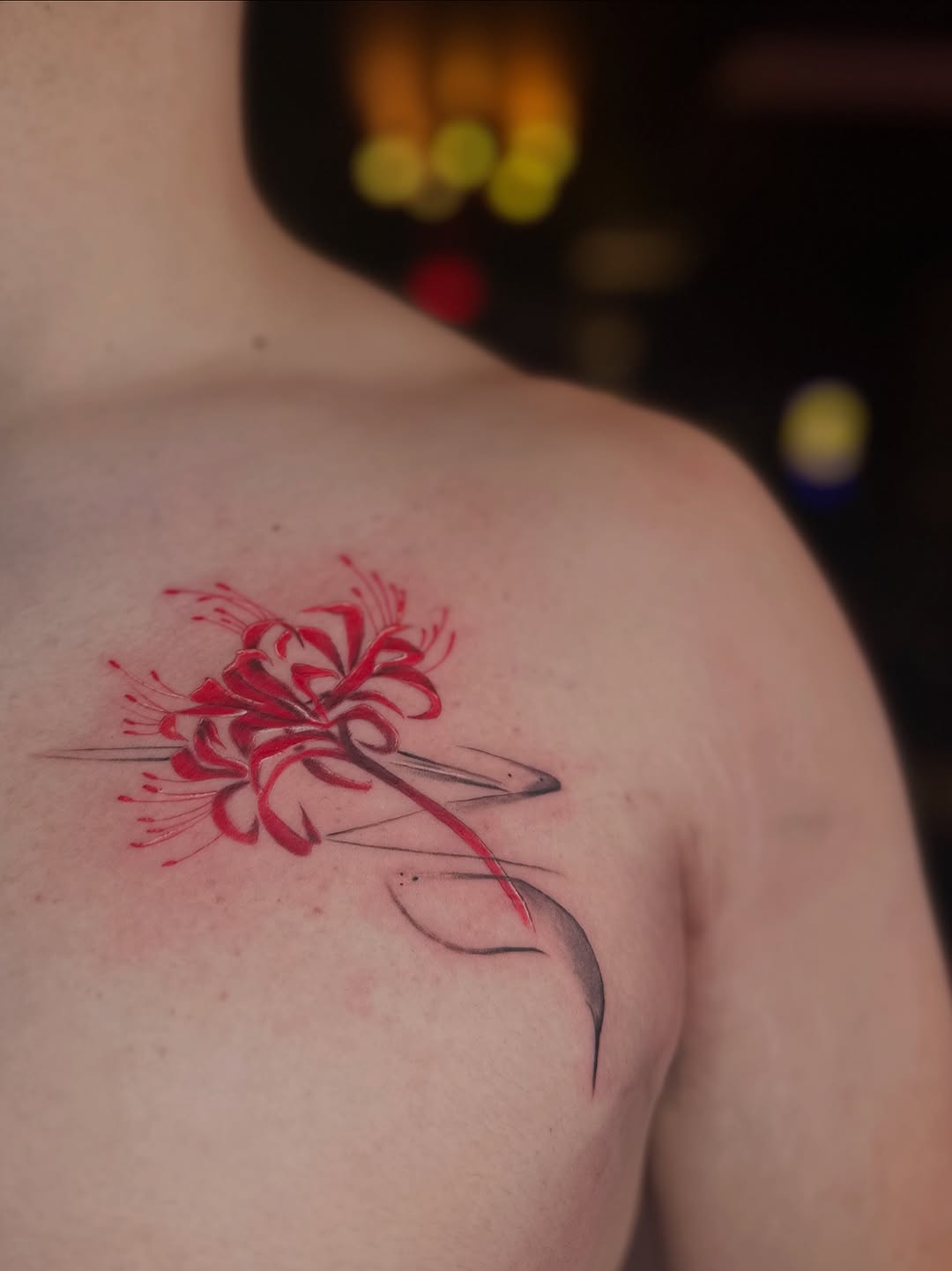 Red spider lily watercolor tattoo on the shoulder by Vu Nguyen