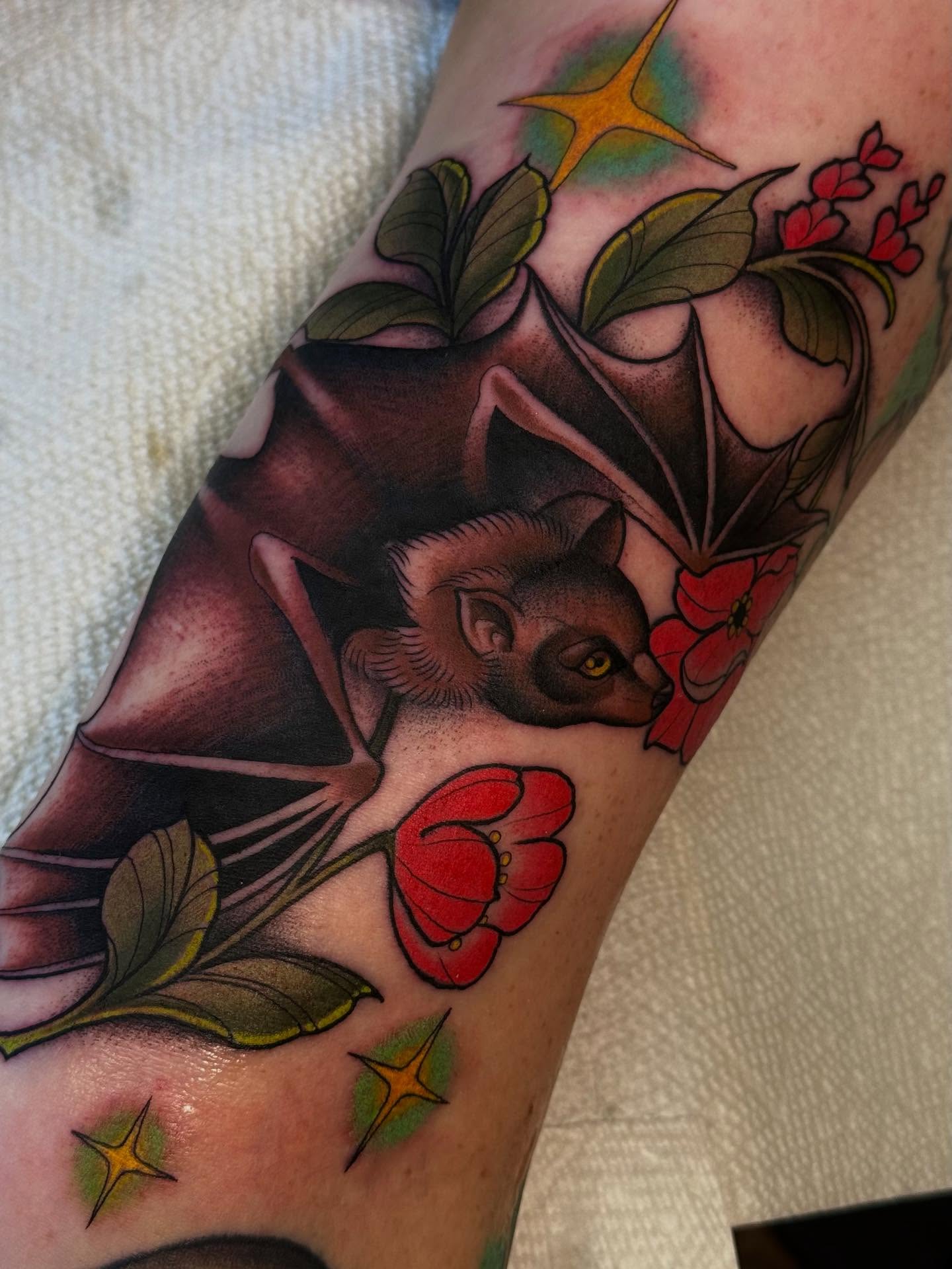 Bat and flowers American traditional tattoo on the forearm by Espinal