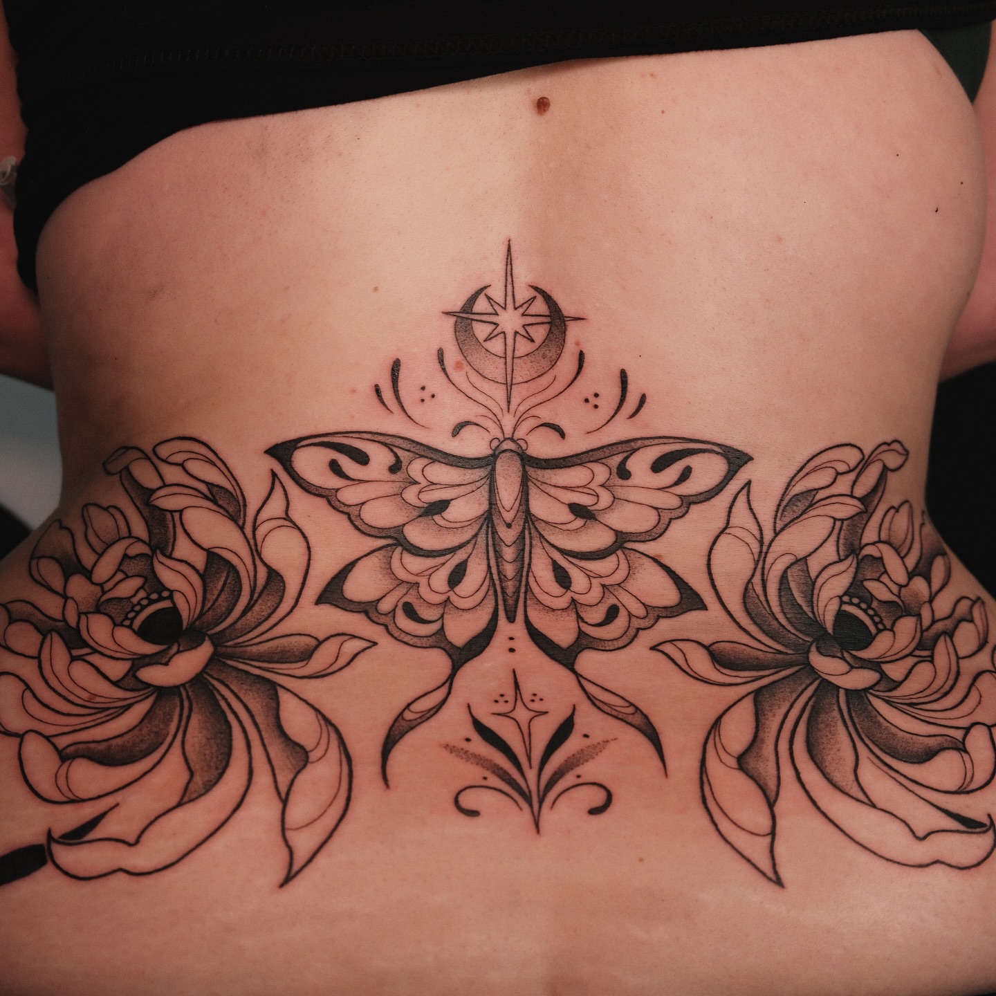 Butterfly and flowers ornamental tattoo on the torso by Velvet, Seattle, Washington