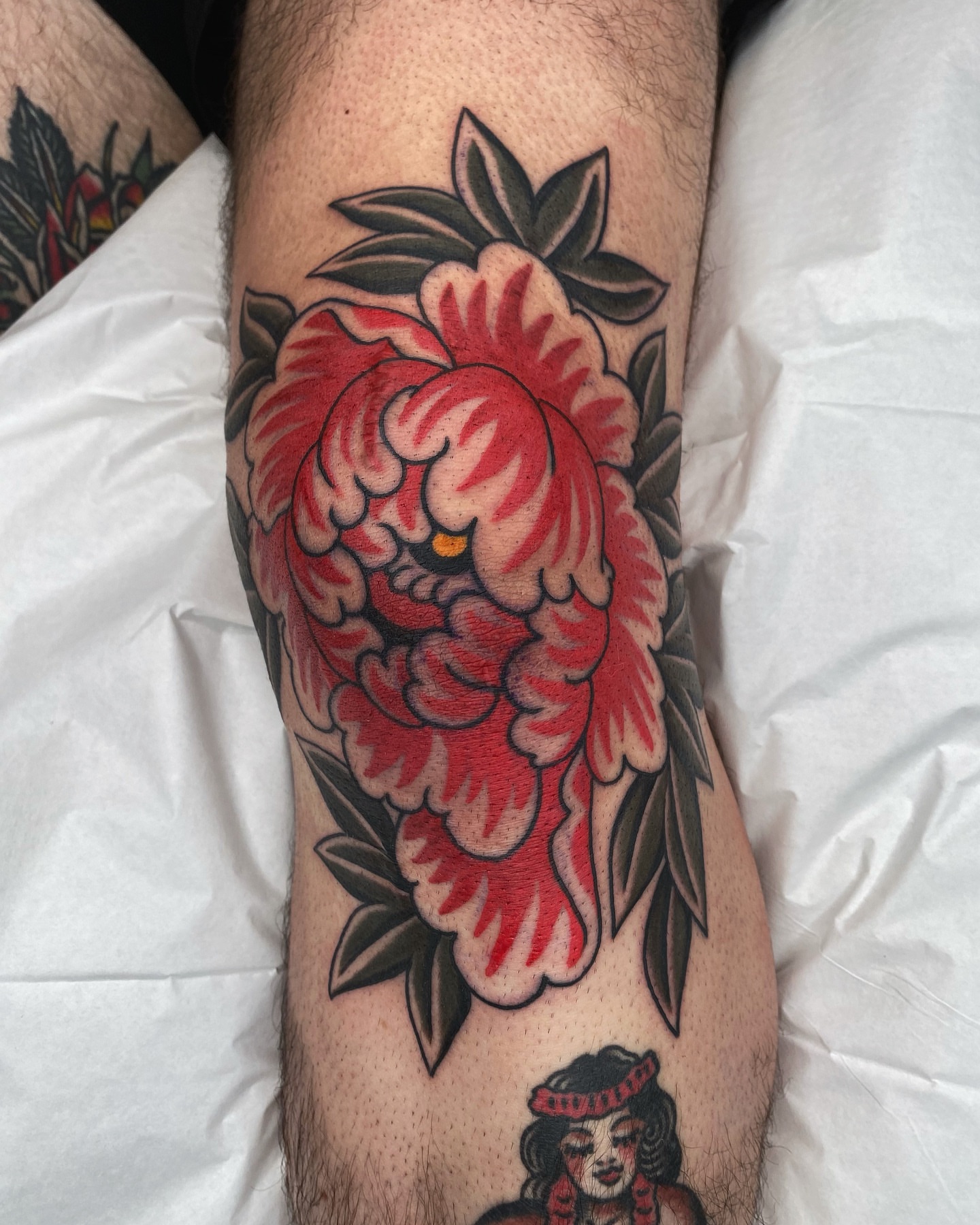 Peony American traditional tattoo on the leg by Wes Hoffman