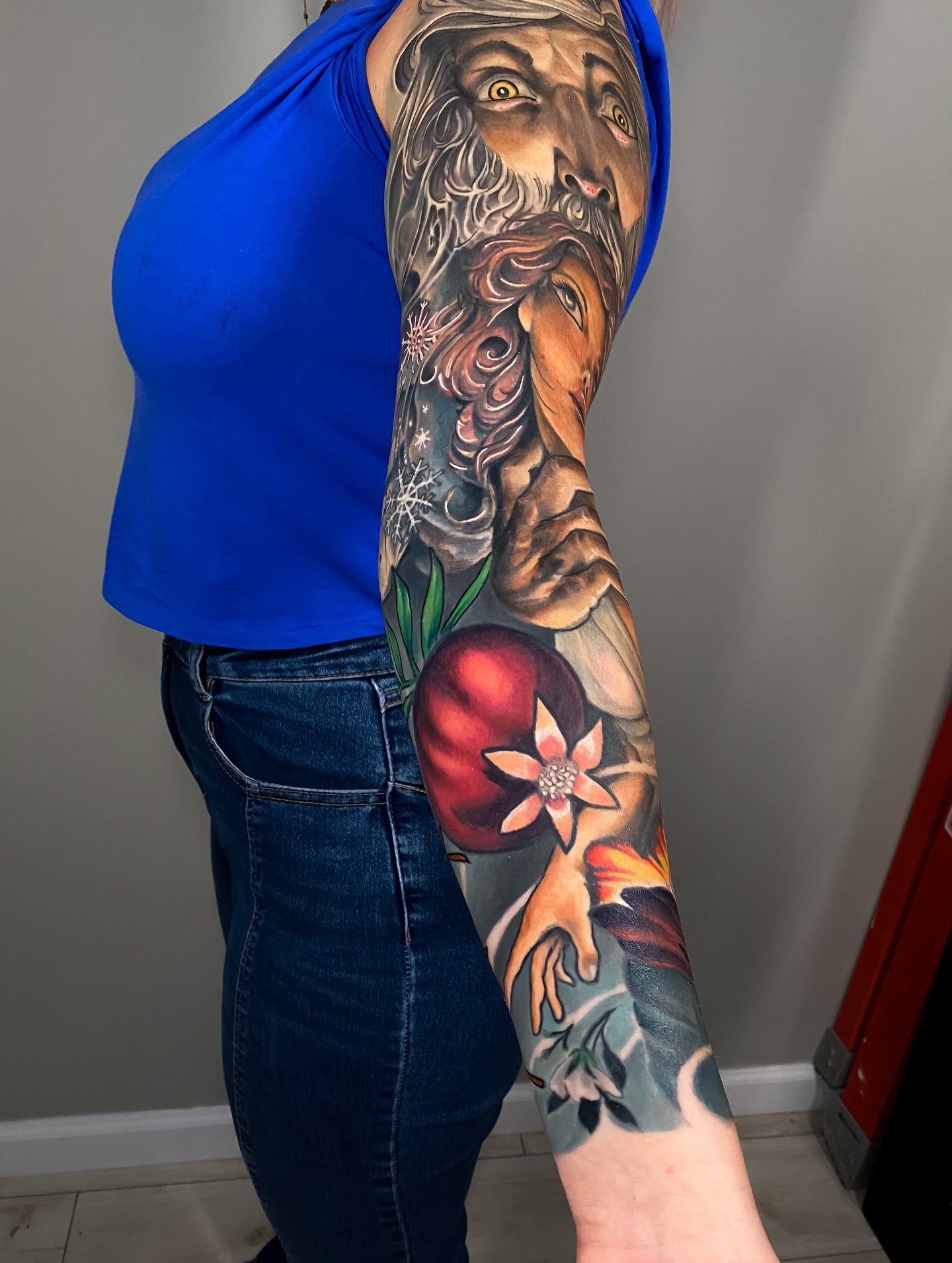 God-like figure with apple realism tattoo on the forearm by Eric James, Phoenix, Arizona