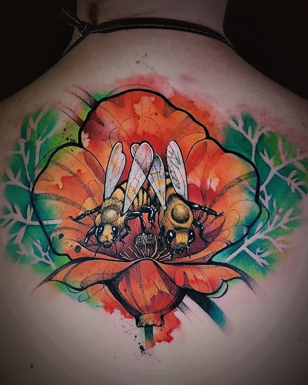 Bees on flower watercolor tattoo on the back by Jorell Elie