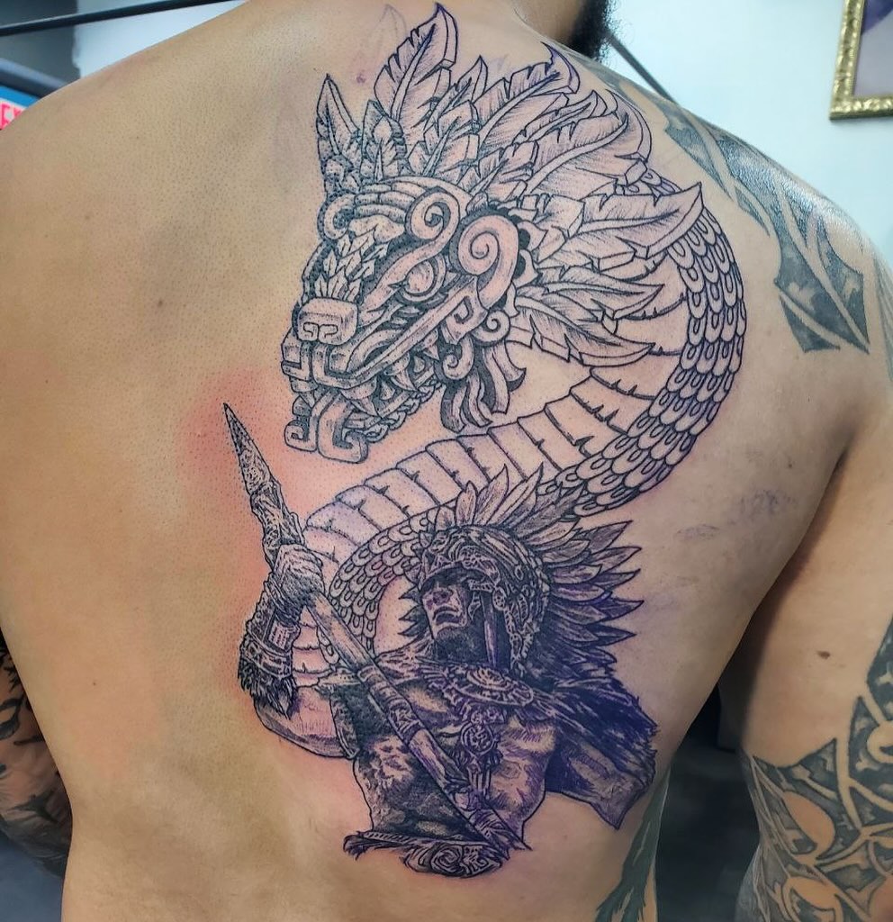 Mexican warrior and serpent realism tattoo on the back by Matthew Ray, Harrisburg, North Carolina