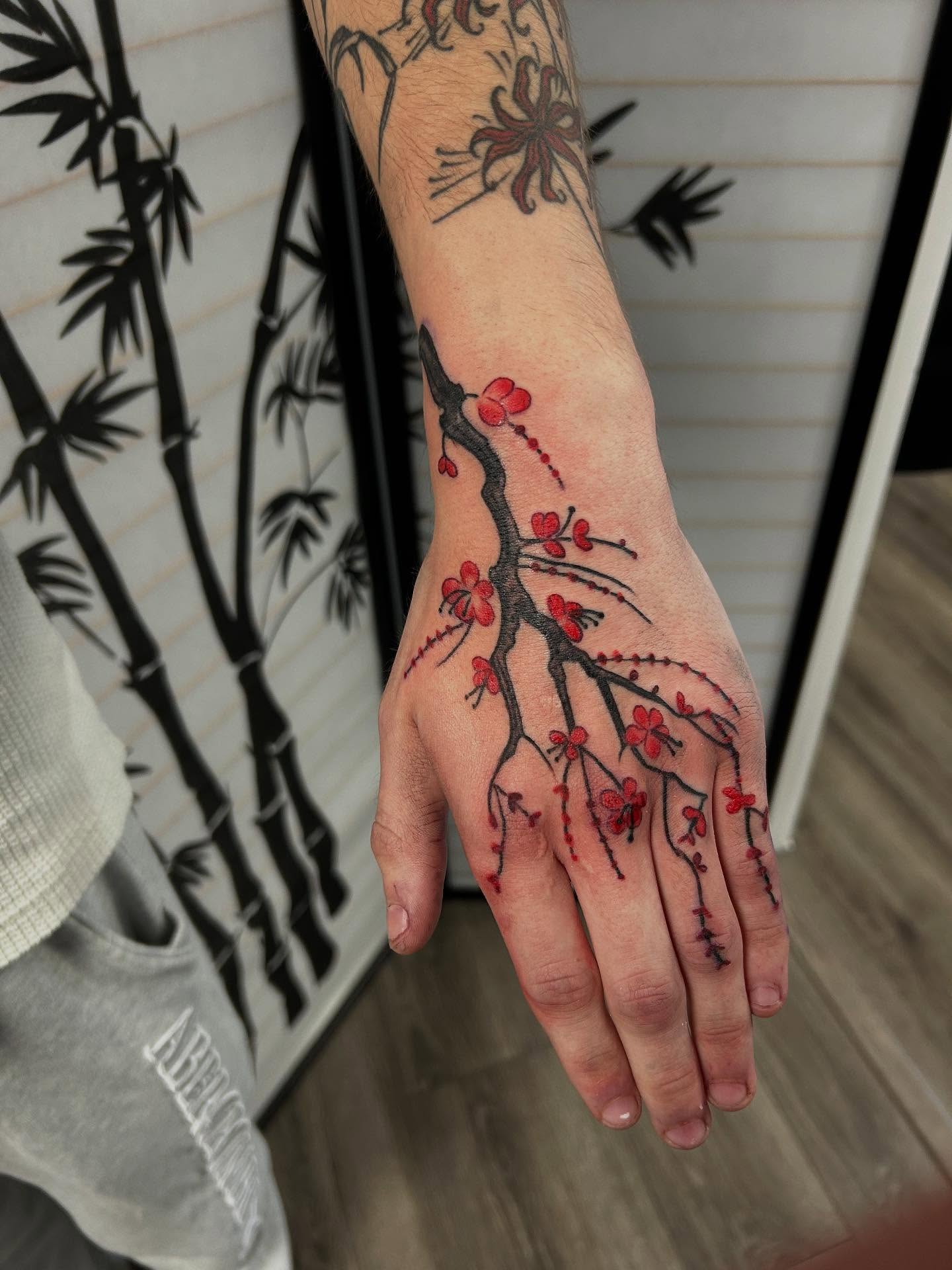 Cherry blossom branch dotwork tattoo on the hand by Shayna Soderstrom, Columbus, Ohio