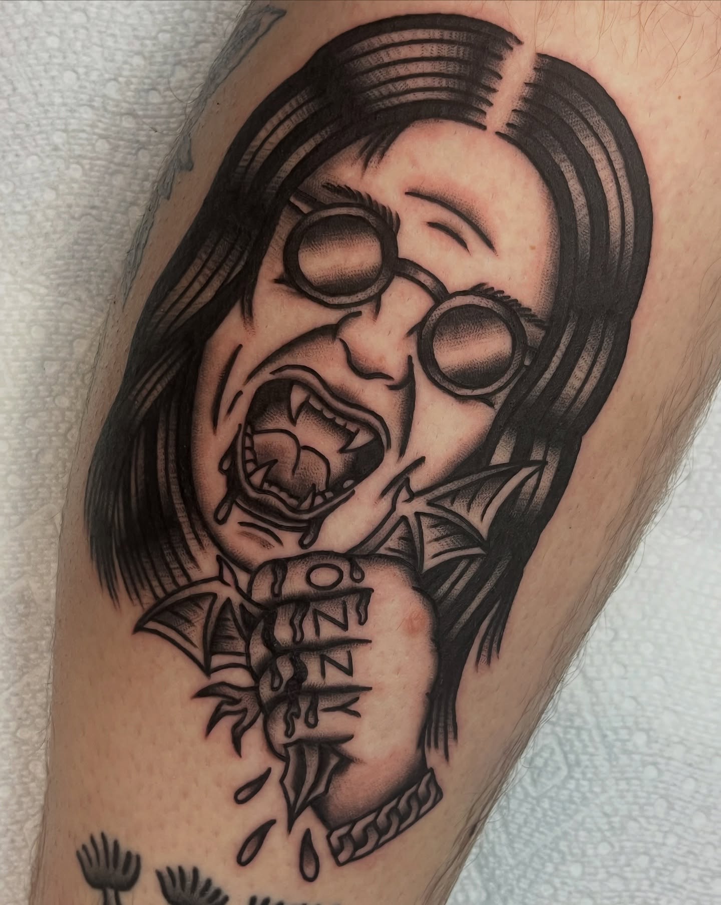 Ozzy Osbourne black and grey tattoo on the forearm by August B., Renton, Washington